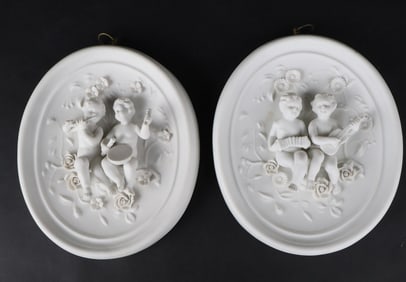 Pair of Bisque Porcelain Wall Plaques of Putti