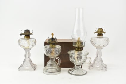 Group of Four Antique Colorless Glass Oil Lamps