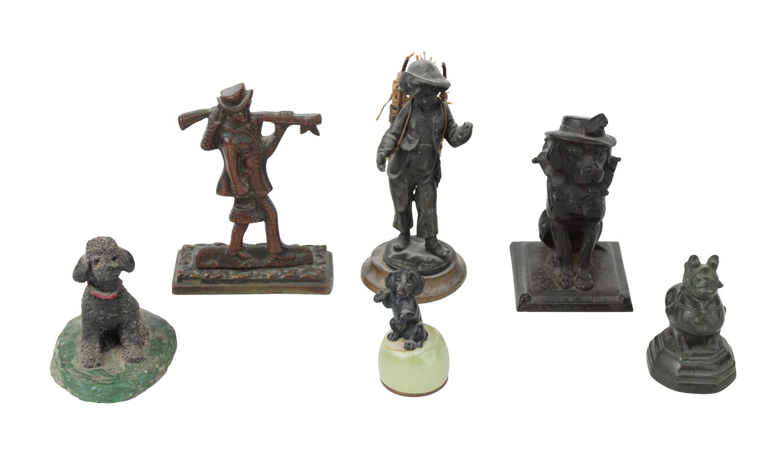 Six Small Metal Figurals: Six Small Metal FiguralsComprising, two boys carrying sticks, a dog in a hat, a poodle, a dachshund, and a Chinese fu-dog.Some wear.Largest: 5 x 2 1/4 in. (12.7 x 5.7 cm.)