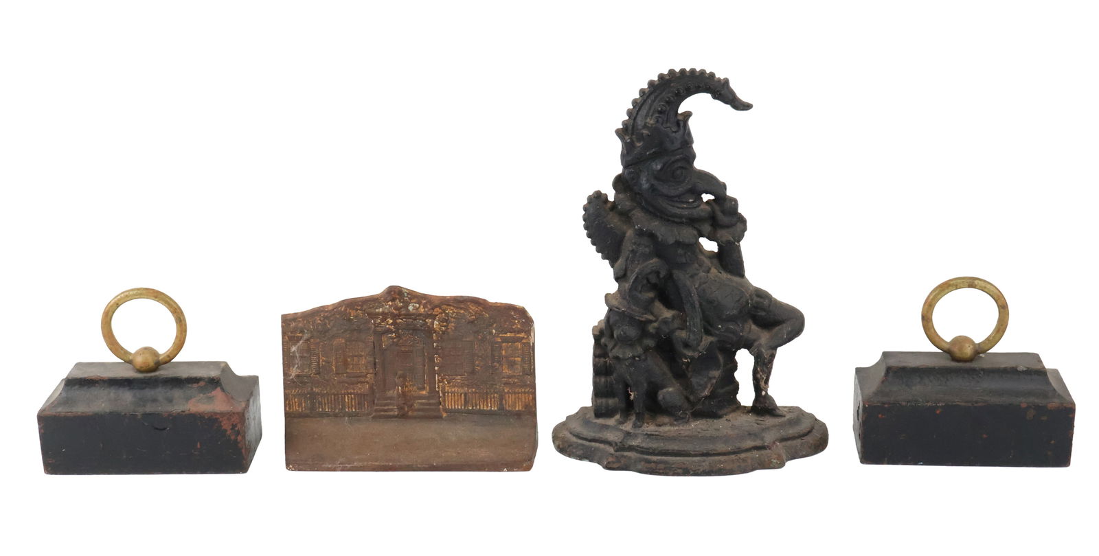 Four Cast-Iron Doorstops: Four Cast-Iron DoorstopsComprising, two block form with ring handles, one of a house, and one of a Punch from Punch and Judy.Losses, wear, surface distress.Largest: 12 1/2 x 9 1/4 x 3 1/2 in. (31.8 x