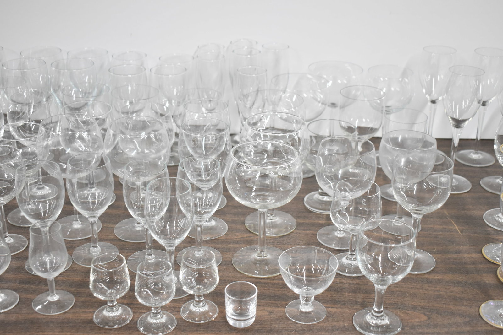 Large Group of Assorted Colorless Glass Stemware: Large Group of Assorted Colorless Glass Stemware Large Group of Assorted Colorless Glass Stemware. Including Brandy Snifters, Champagne, Tumblers, Wine glasses and more. Used condition, approximately 