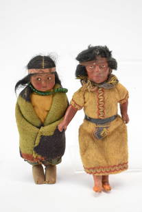 Skookum Native American Doll of Young Girl: Skookum Native American Doll of Young GirlSkookum Native American Doll of Young Girl with wrapped wooden feet. Together with composition doll of man. Used condition, wear, worn, losses. Man measures 7