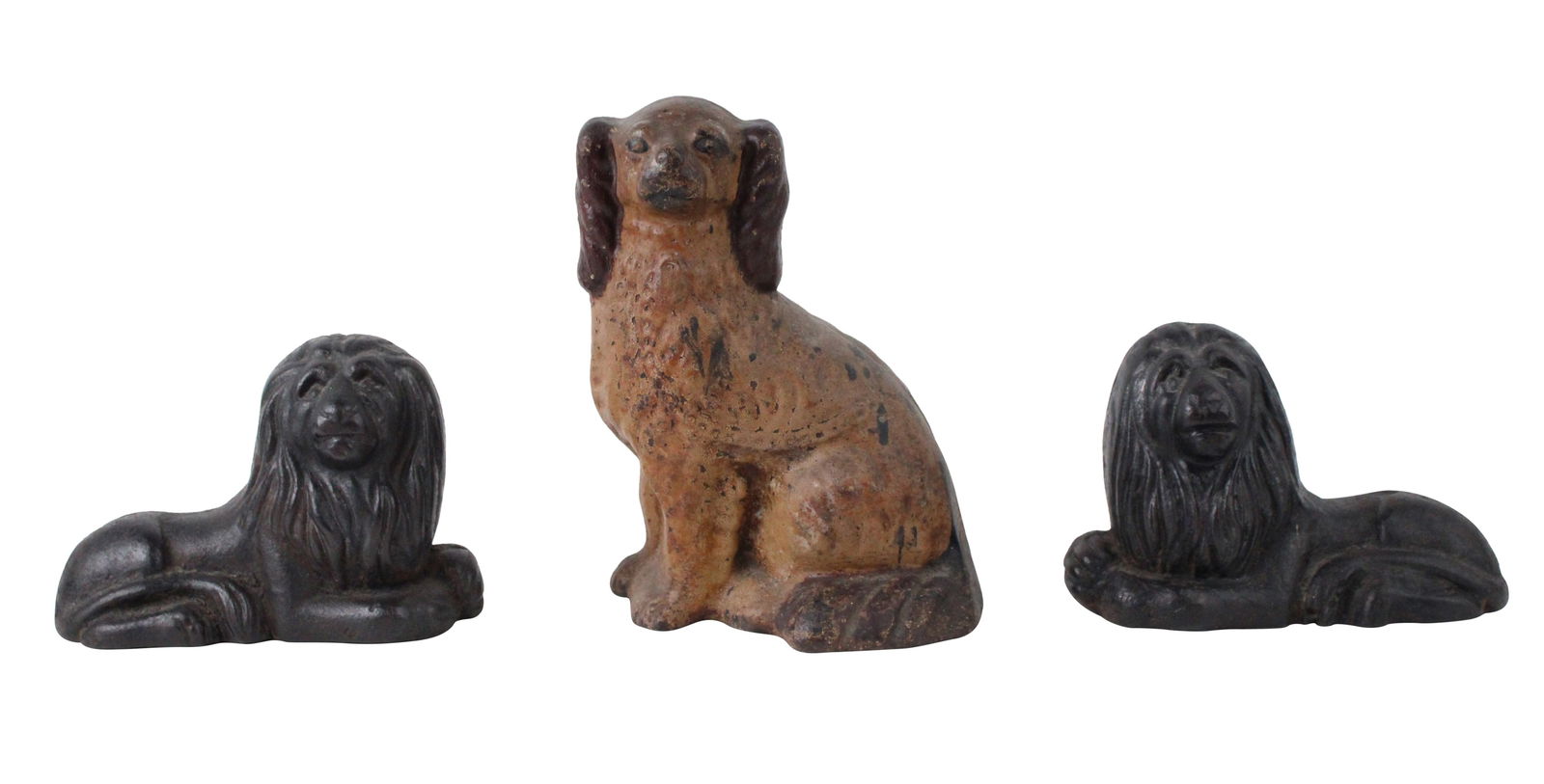 Pair of Cast-Iron Resting Lion Doorstops: Pair of Cast-Iron Resting Lion Doorstops19th/20th C. Together with a spaniel cast-iron doorstop. 3 pieces.Lion: 5 1/2 x 7 3/4 x 3 1/2 in. (14 x 19.7 x 8.9 cm.)
