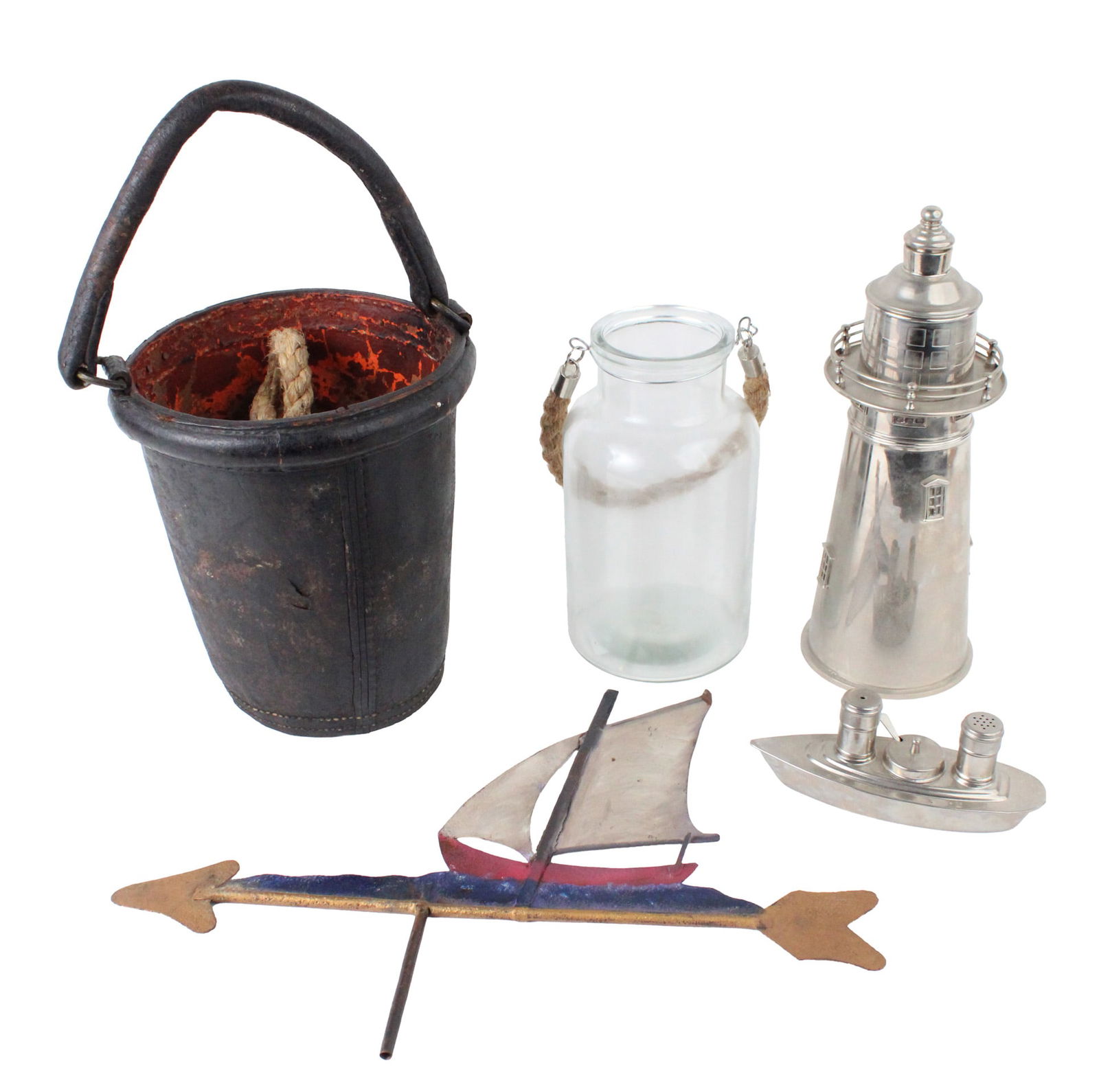 Six Maritime Themed Decorative Objects: Six Maritime Themed Decorative ObjectsComprising, a boat-form salt and pepper shaker, a sailboat form weathervane, a lighthouse, a glass jar with rope handle, a leather bucket, Stamped Navy Yard Washi
