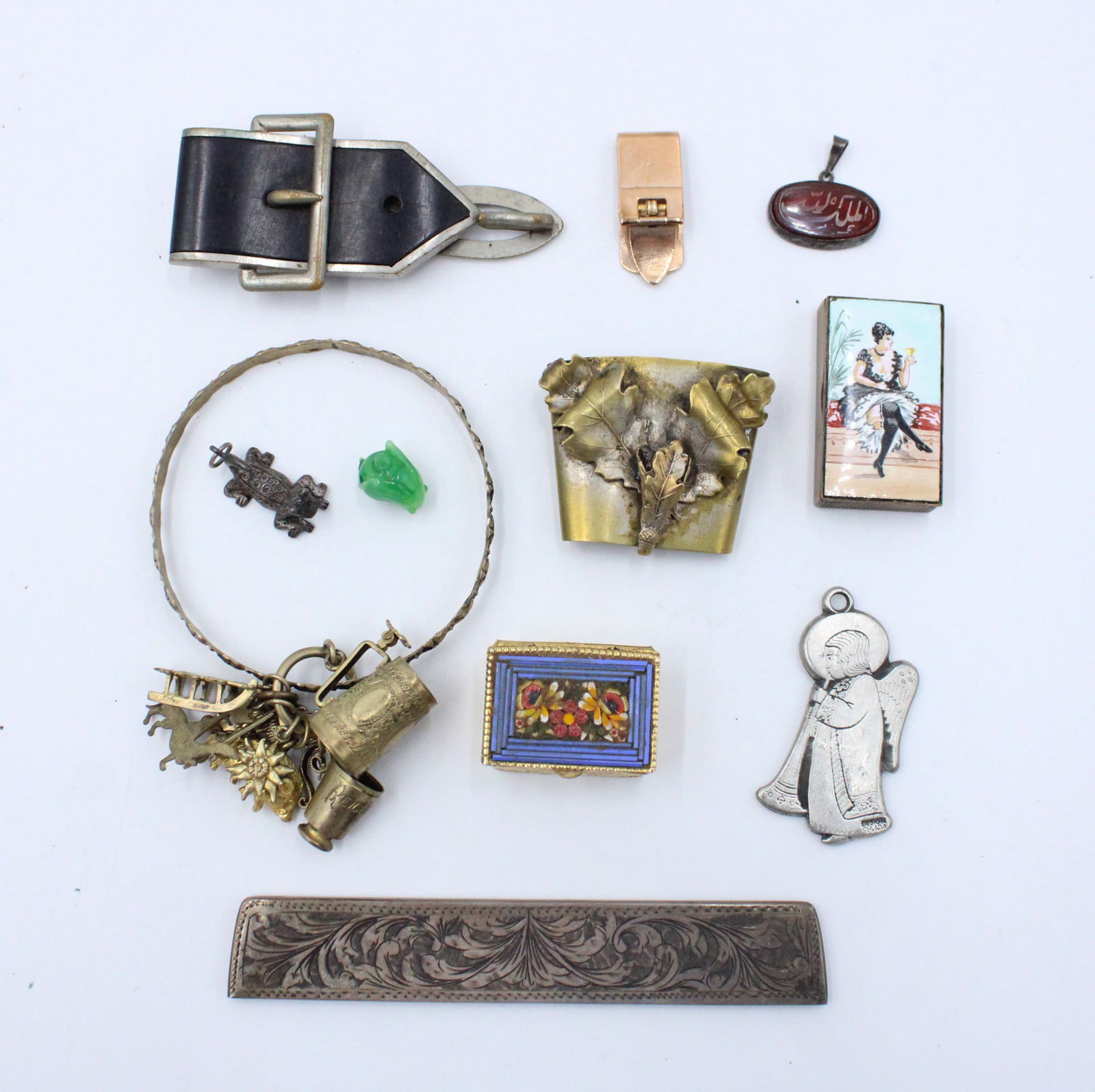 Group of Miscellaneous Trinkets: Group of Miscellaneous TrinketsIncludes a bone cigarette holder, a compass, pins, pill boxes, lockets, stones, and other objects.Dimensions vary.