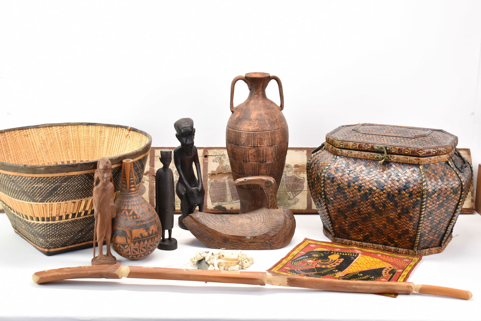 Group of Assorted Asian and African Articles: Group of Assorted Asian and African ArticlesGroup of Assorted Asian and African Articles. Including figural wood carvings, wood duck carving, vessels, bone and horn necklace Hindu musical panel 33 1/2