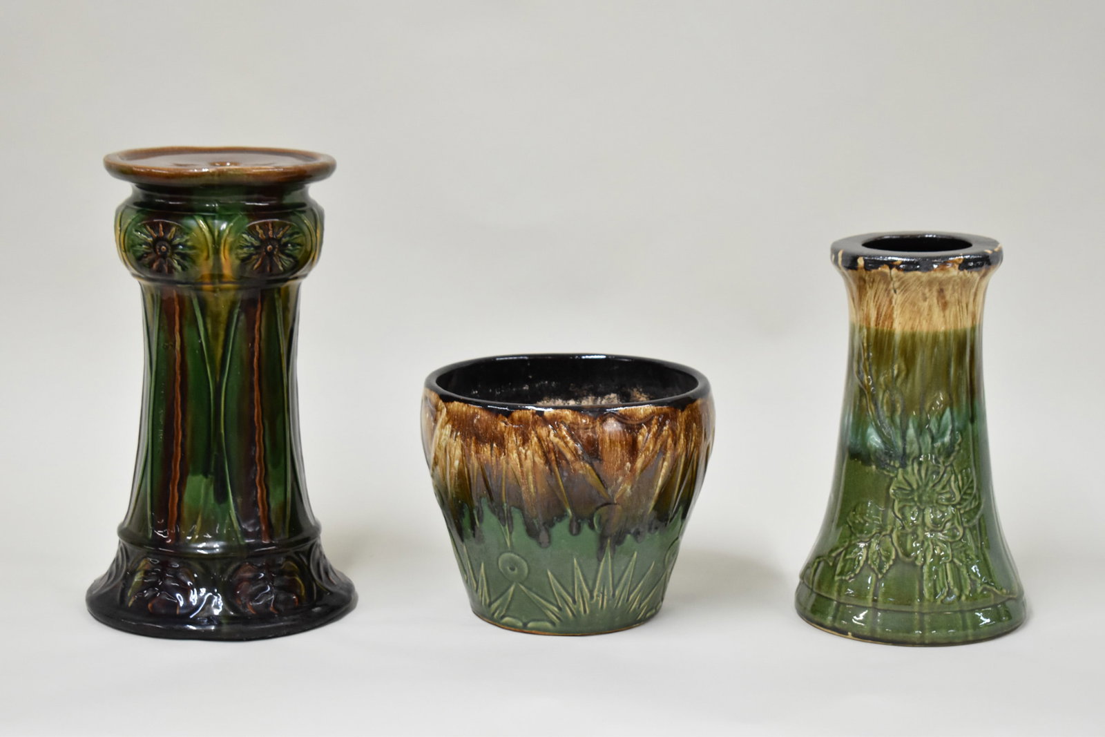 Two Vintage Weller Style Pedestals: Two Vintage Weller Style Pedestals. Together with a similar Jardinière possibly Robinson Rainsbottom. Used condition, tallest Pedestal measures16 1/2" tall with chip to base, Jardinière measures 8 3