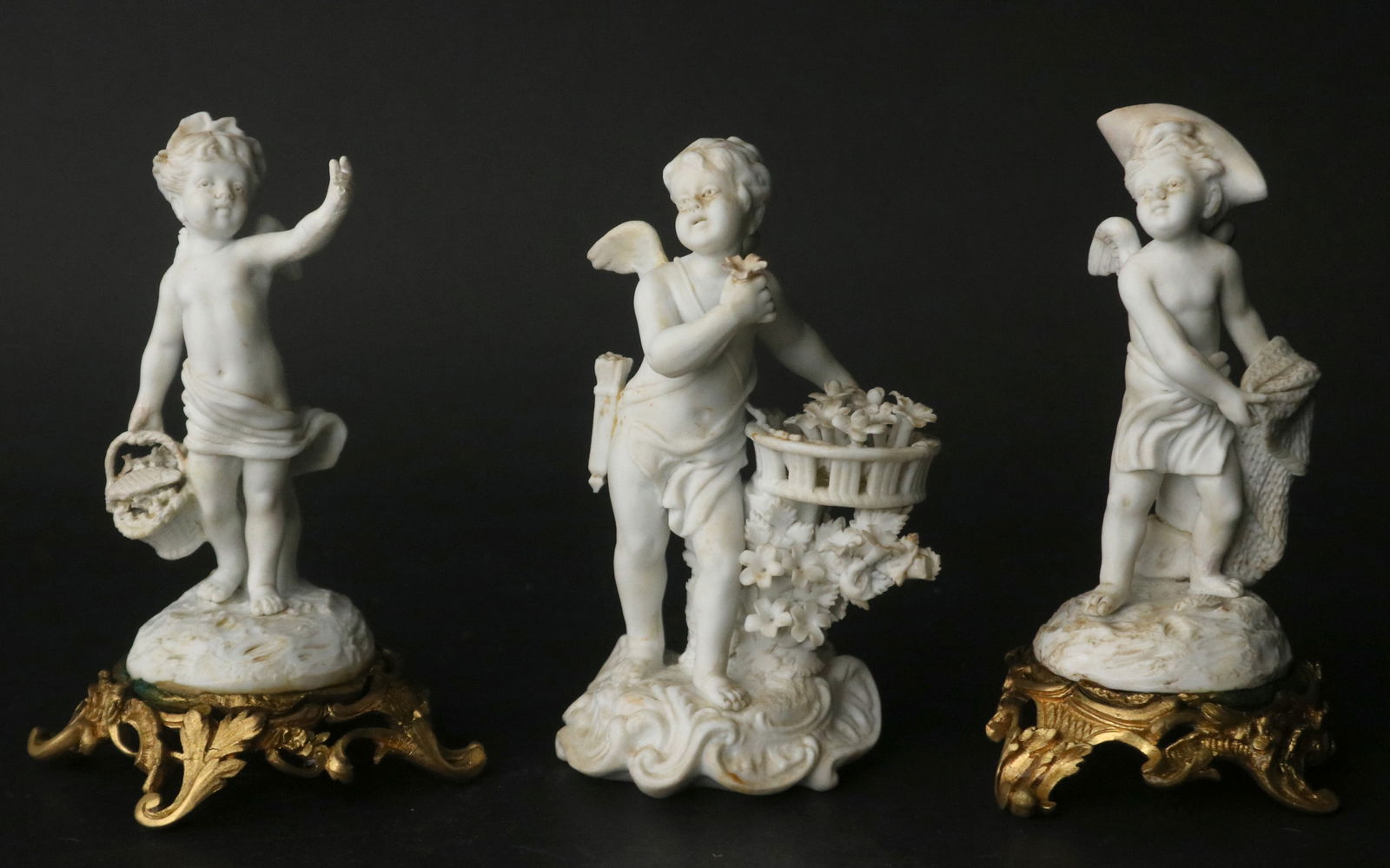 Three Bisque Porcelain Putti Figures: Three Bisque Porcelain Putti FiguresFrench, 19th/20th C. two ormolu mounted, unsigned.5 1/2 x 3 3/4 x 3 1/2 in. (14 x 9.5 x 8.9 cm.)