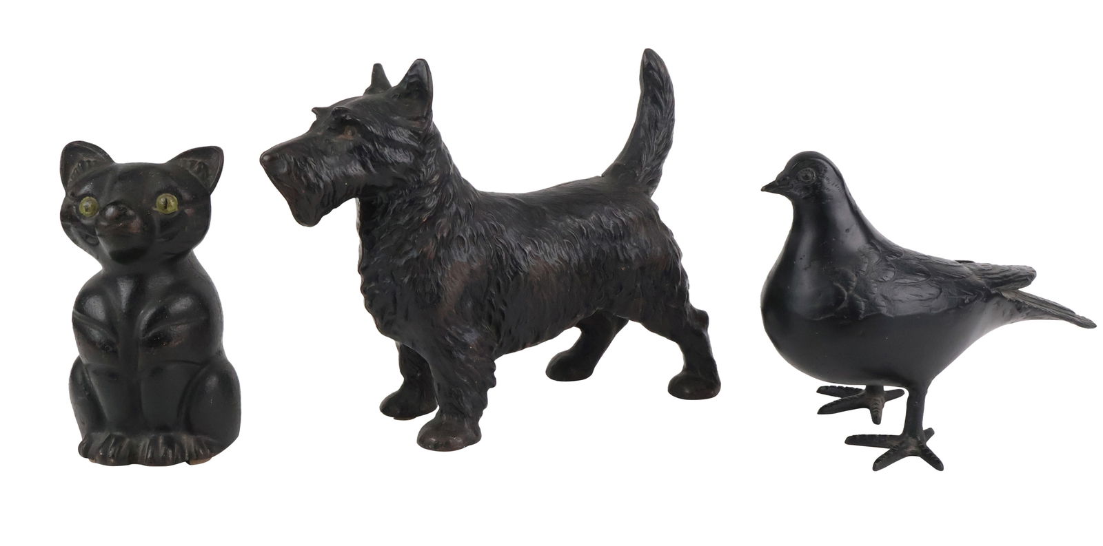 Scottie-Form Cast Iron Doorstop: Scottie-Form Cast Iron DoorstopTogether with a black-painted cast-iron pigeon and a cast-iron cat-form doorstop. 3 piecesLosses to paint, wear.Scottie: 9 x 10 1/2 x 3 1/2 in. (22.9 x 26.7 x 8.9 cm.)