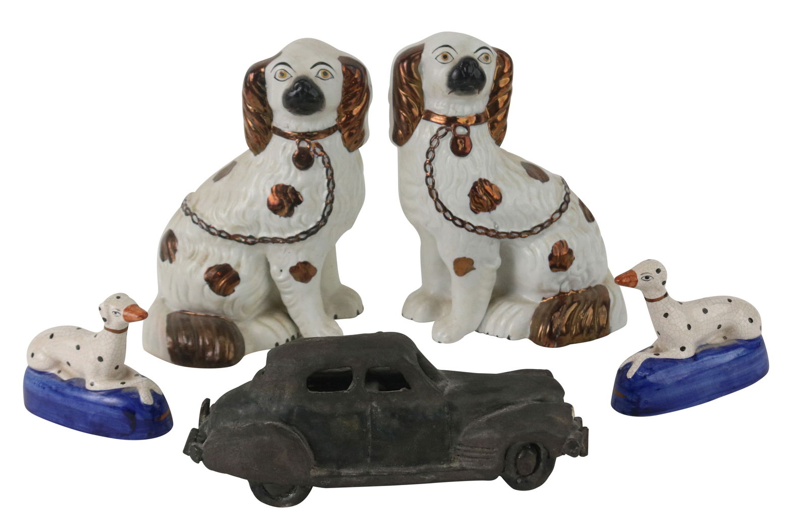 Two Pairs of Staffordshire Dogs: Two Pairs of Staffordshire DogsComprising, a pair of spaniels and a pair of dalmatians. Together with a ceramic sculpture of a car. 5 piecesLargest: 9 1/2 x 7 1/4 x 5 1/4 in. (24.1 x 18.4 x 13.3 cm.)