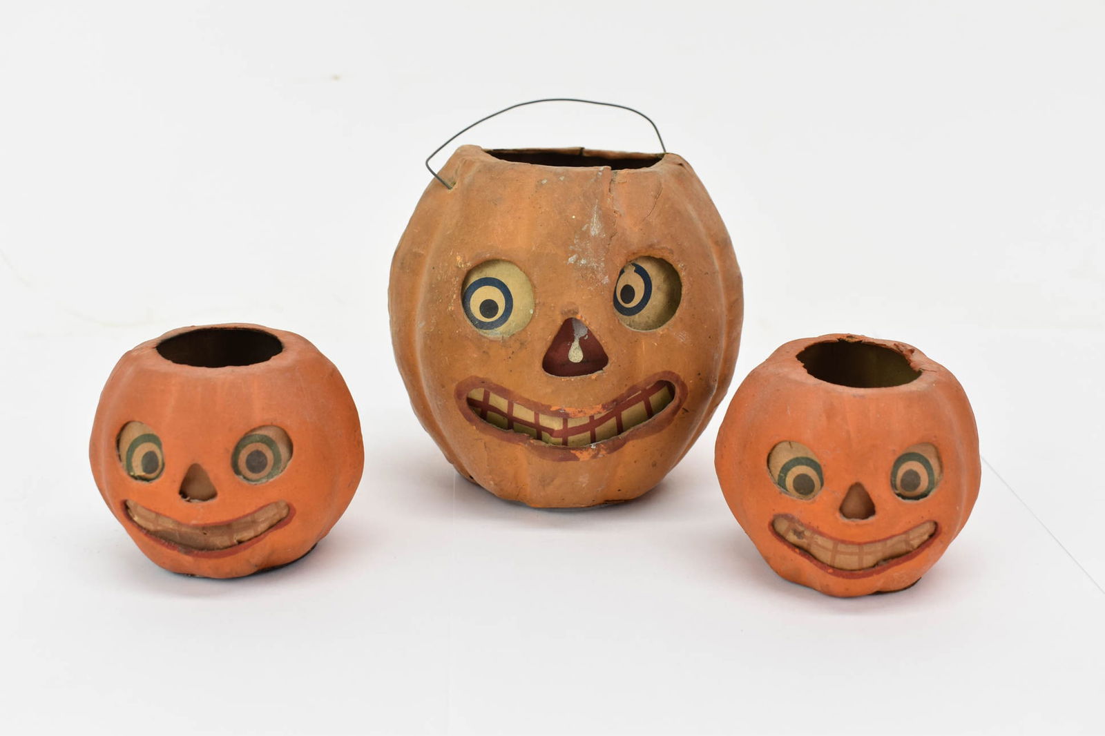 Vintage Paper Jack O Lantern: Vintage Paper Jack O LanternVintage Paper Jack O Lantern with wire handle. Together with a pair of smaller Jack O Lanterns. Used condition, wear, worn, losses. Largest measures 4" tall x 4" diameter