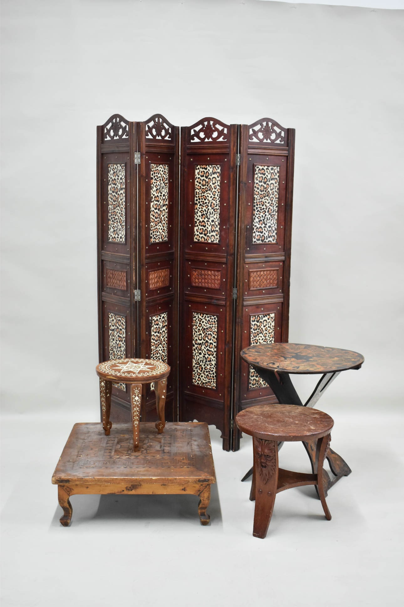 Three Inlaid Tables: Three Inlaid Tables One a low square table, one a round bone-inlaid stand, and one folding. Together with a carved wood side table and faux leopard folding screen. Losses, wear, surface distress. Fold
