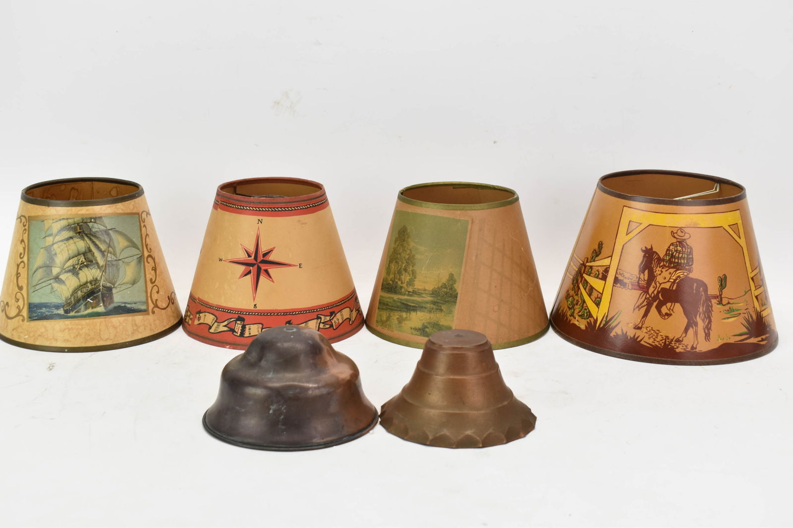 Vintage Group of Assorted Lamp Shades: Vintage Group of Assorted Lamp ShadesVintage Group of Assorted Lamp Shades. Comprising two copper shades, paper shade depicting cowboys and horses, two paper shades with ship and anchor, along with on