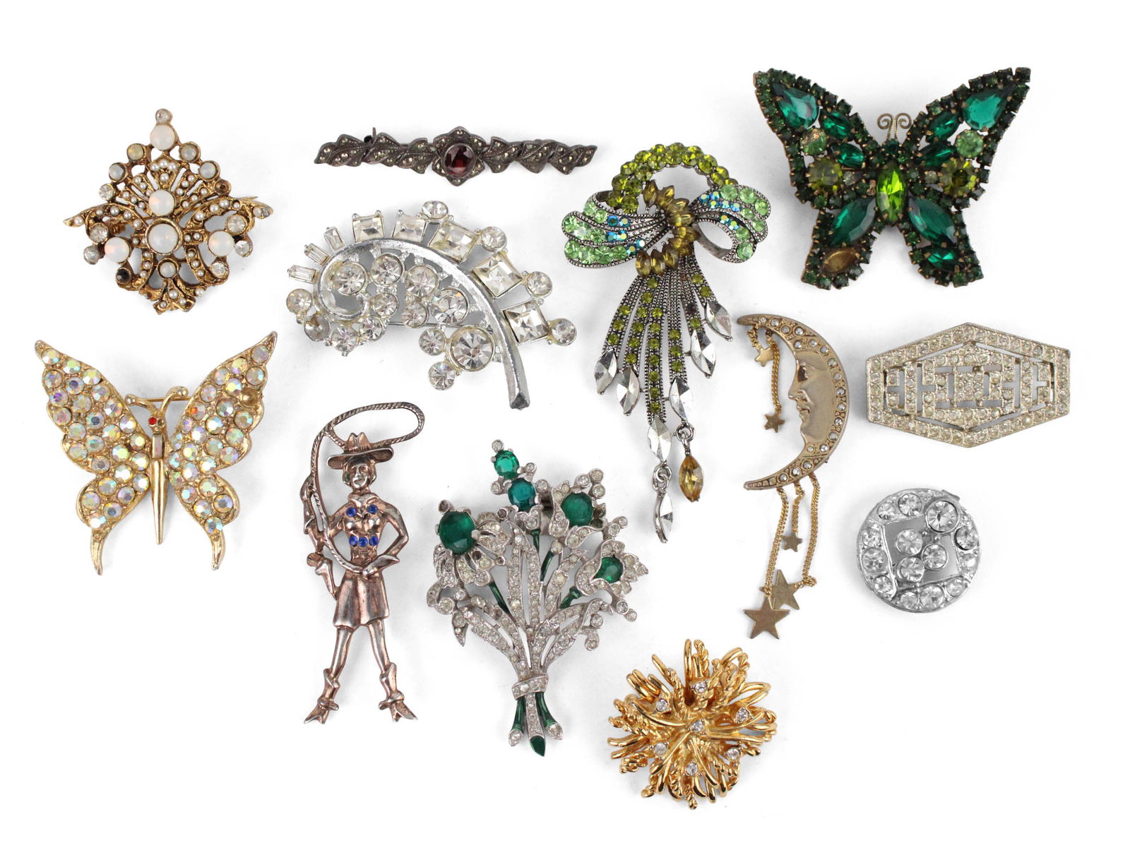 Large Group of Costume Jewelry: Large Group of Costume JewelryIncluding, Trifari Astra, Reid, Baer, a large group of rhinestones, paste, and number of sterling pins, and a sterling cowgirl.