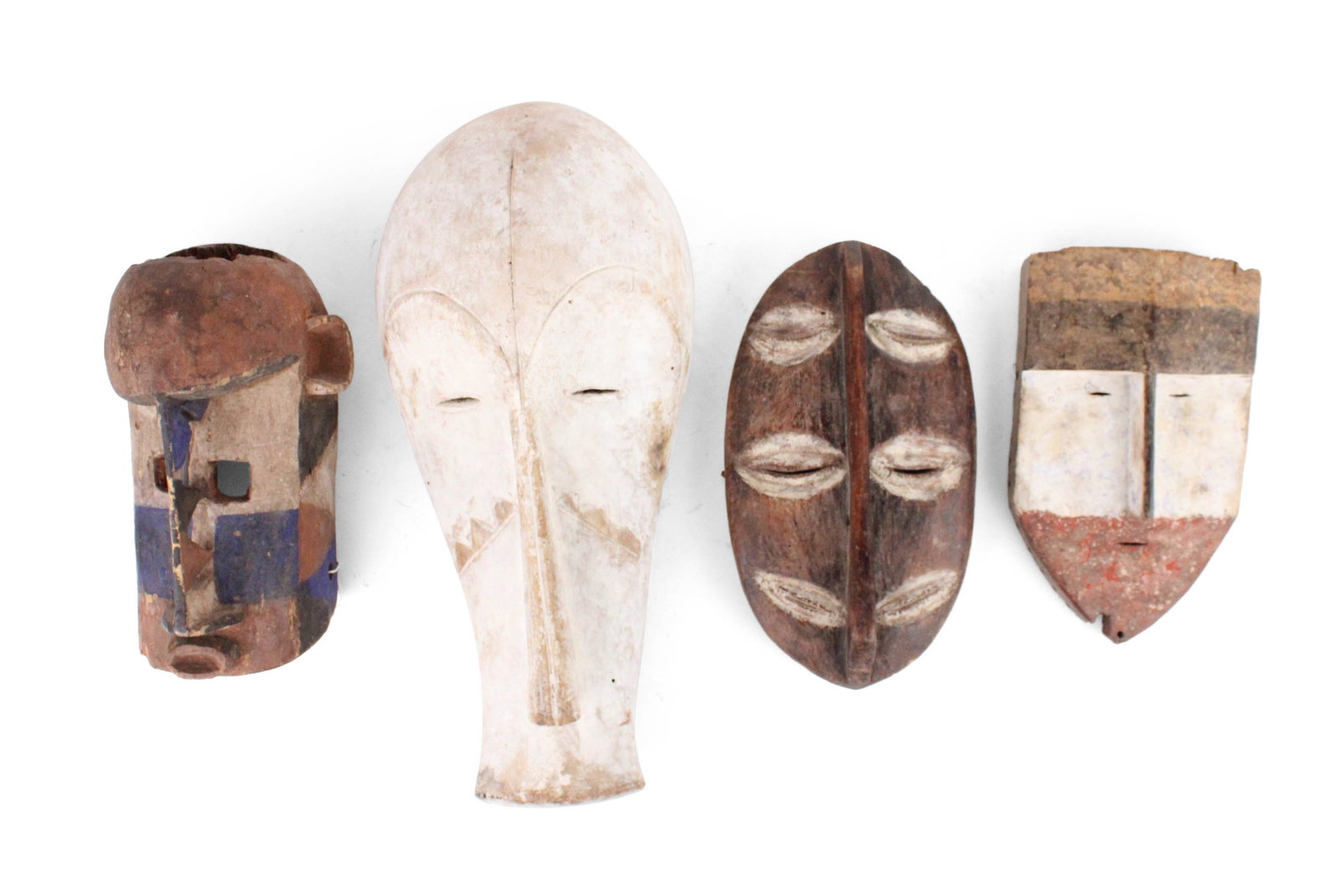 Four African and Papua New Guinea Carved Wood Tribal Masks: Four African and Papua New Guinea Carved Wood Tribal Masks Possibly reproductions, including, Iswere, Fang and Garra. Losses, wear, surface distress. Largest: 21 in. (53.3 cm.)