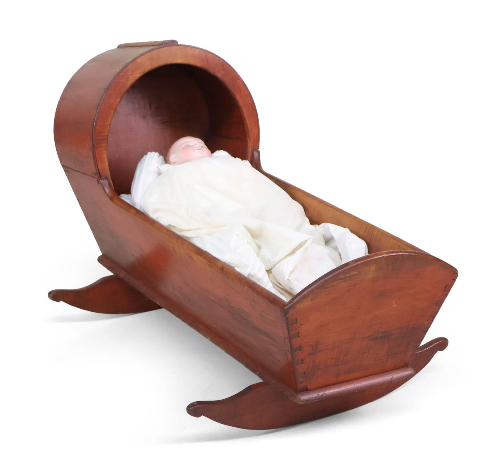 Grace Putnam Doll in a Federal Rhode Island Cradle: Grace Putnam Doll in a Federal Rhode Island CradleRhode Island, c. 1790.From the Consignor: On the trip she also bought a Rhode Island cradle with original red paint, circa 1790. Once Peter and I saw