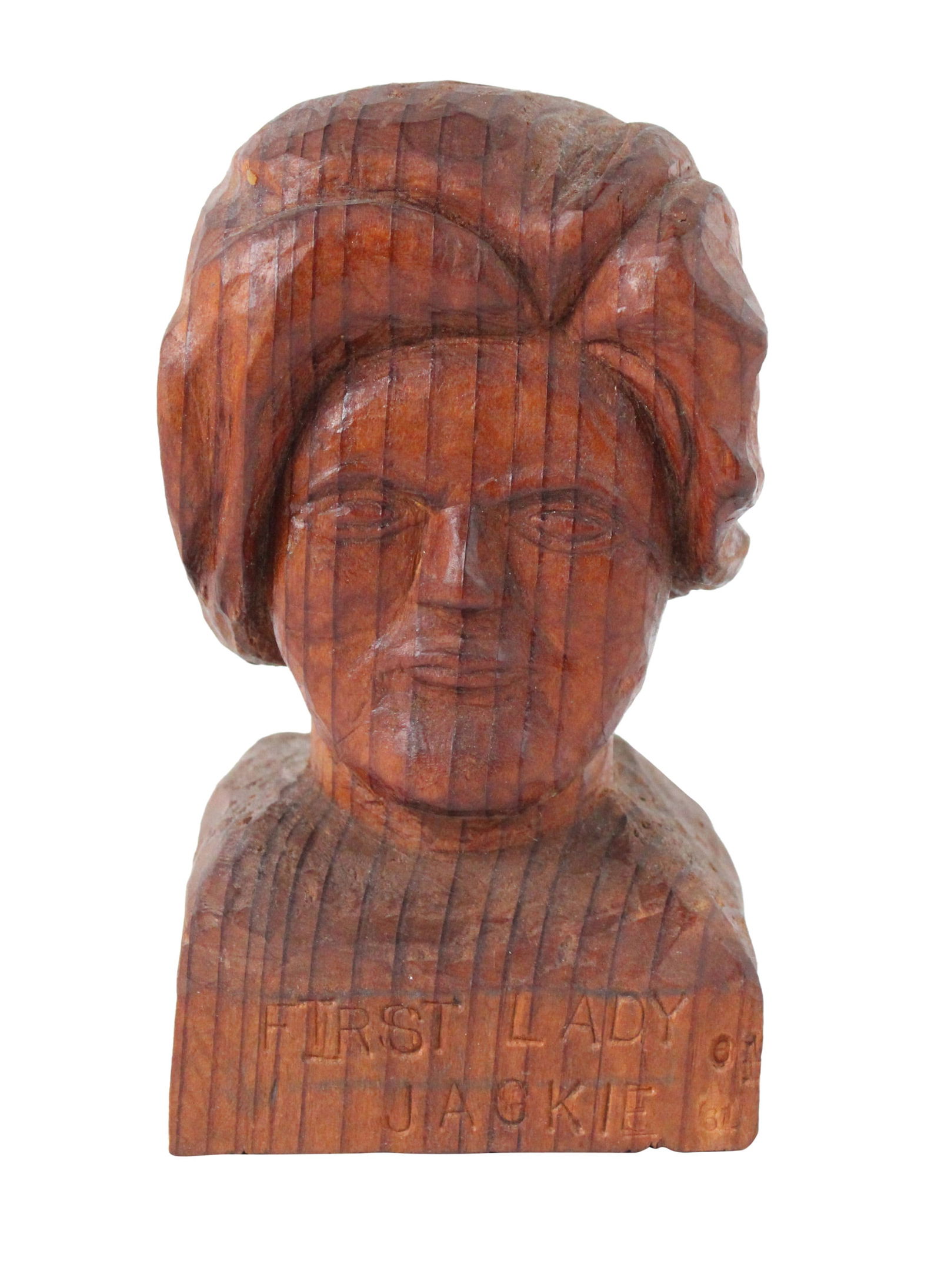 Carved Wood Bust of Jackie Onassis: Carved Wood Bust of Jackie OnassisAmerican, 20th C. Inscribed "First Lady Jackie".Provenance: Property from a Private New England Collection6 x 3 1/2 x 3 in. (15.2 x 8.9 x 7.6 cm.)