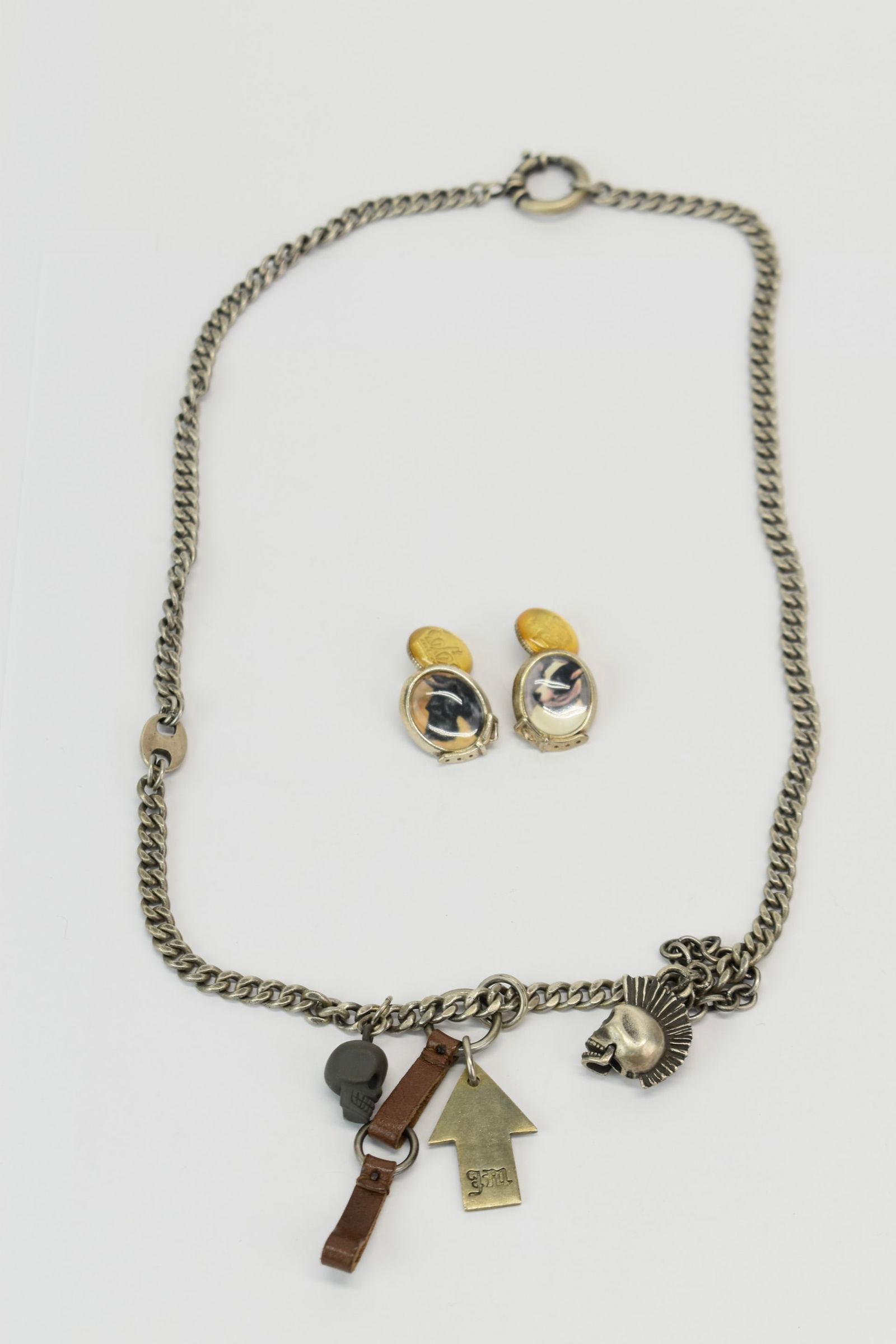 Chunky Sterling Silver Juicy Couture Men's Punk Fetish Necklace: Chunky Sterling Silver Juicy Couture Men's Punk Fetish NecklaceSterling Silver Juicy Couture Men's Punk Fetish Necklace having a skull with a mohawk and articulated jaw, an arrow charm, a leather fob