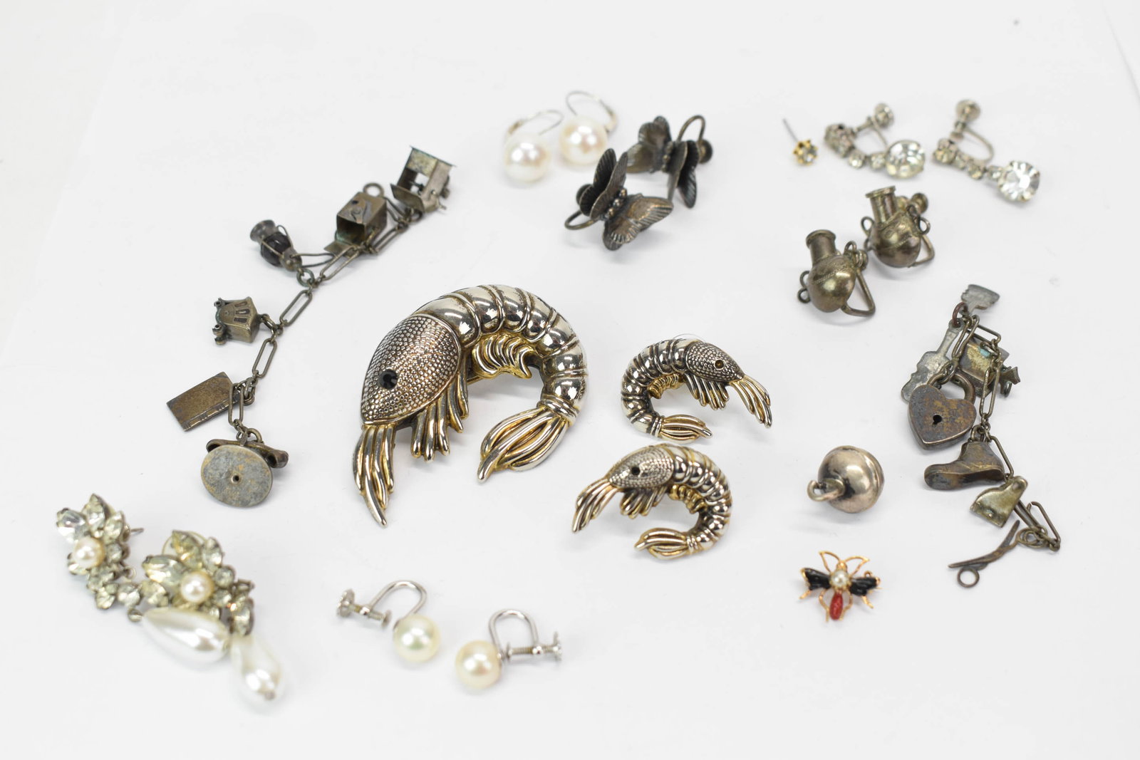 Group of Assorted Ladies Sterling Silver Earrings: Group of Assorted Ladies Sterling Silver Earrings Group of Assorted Ladies Sterling Silver Earrings. Together with assorted earrings, charms, and a three piece shrimp brooch. Used condition, wear,