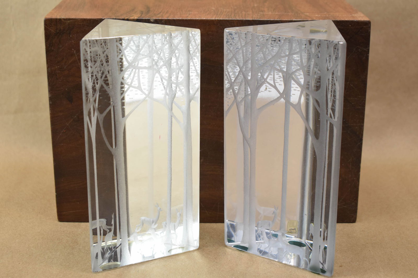 Two Kosta Boda Glass Sculptures, Triangular Prism Deer Forest: Two Kosta Boda Glass Sculptures, Triangular Prism Deer ForestTwo Kosta Boda Glass Sculptures, Triangular Prism Deer ForestUsed condition, wear, worn.6 3/4"h x 3 1/4"w x 3 1/4"d