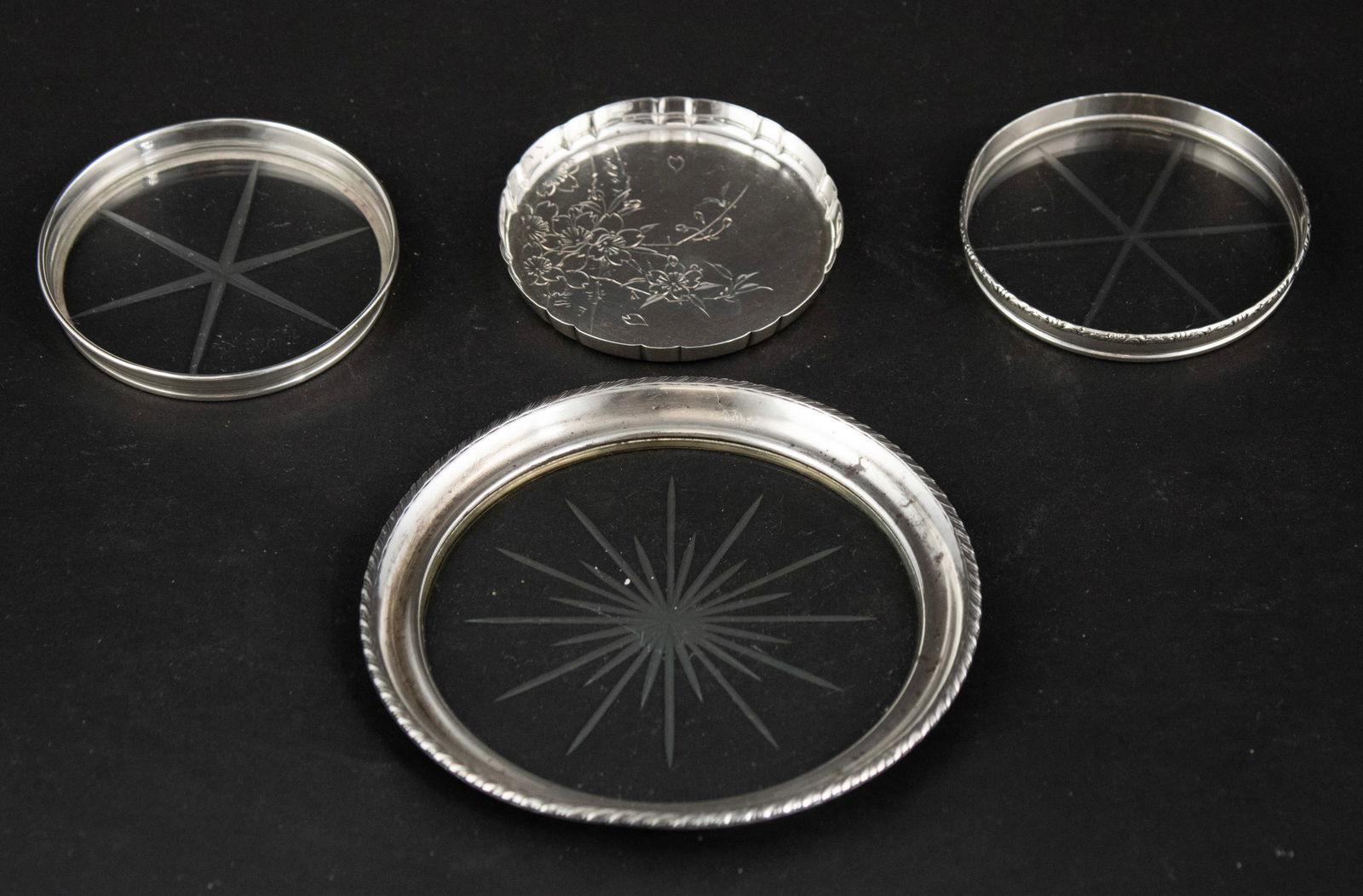 Six Sterling Silver Coasters: Six Sterling Silver Coasters Approx. 5 t.o. Together with a glass and sterling coaster, and nine similar glass and sterling coasters. 3 in. (7.6 cm.)
