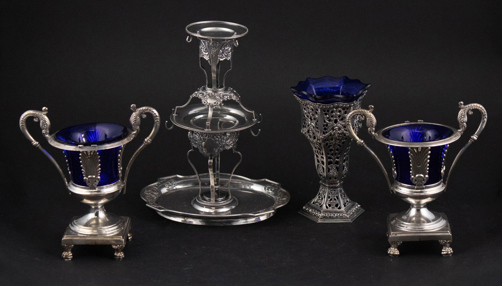 Pair of French Silver Footed Urns: Pair of French Silver Footed Urns The blue glass inserts of later dates and with missing elements and losses. Together with an 825 silver vase with blue glass insert and a Continental silver epergne.