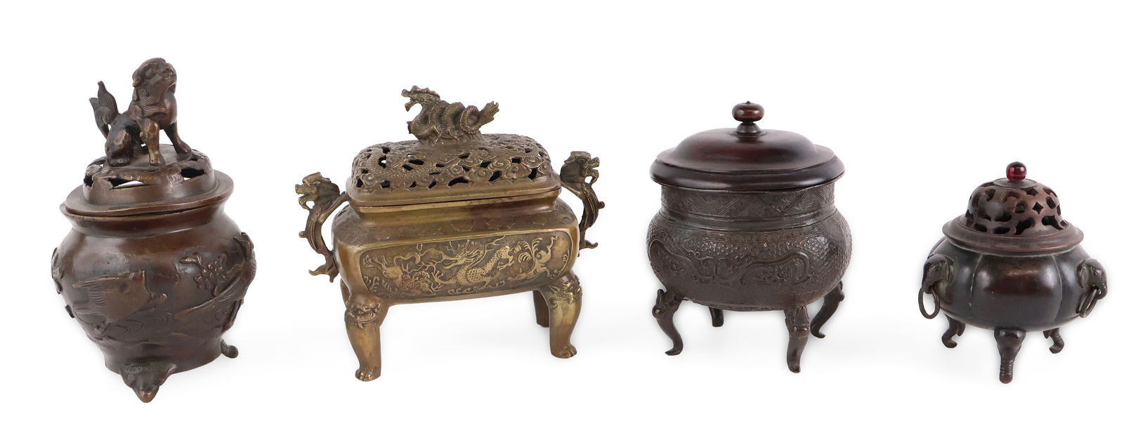 Three Chinese Incense Burners: Three Chinese Incense Burners One brass, one with fu-dog finial, and one with wood lid. Together with a Chinese repousse bronze footed censer with wood lid. 4 pieces Largest: 6 1/2 x 7 1/2 x 3 1/2
