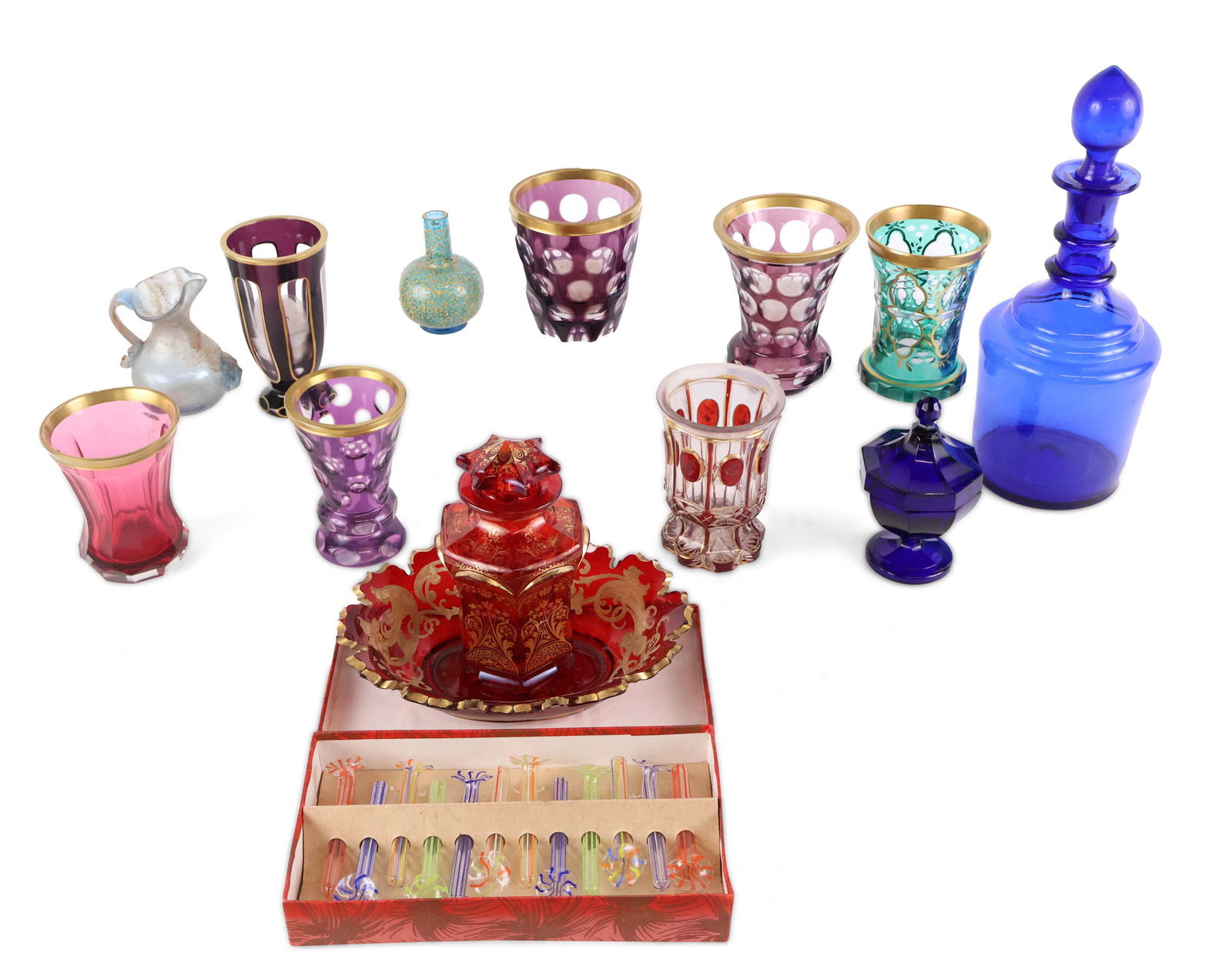 Group of Colored Glass Table Articles: Group of Colored Glass Table Articles Including, a boxed set of Murano style glass tubes, a Roman style pitcher, a blue decanter, Bohemian style glasses, bowl, and vases. 14 pieces Chips, wear,