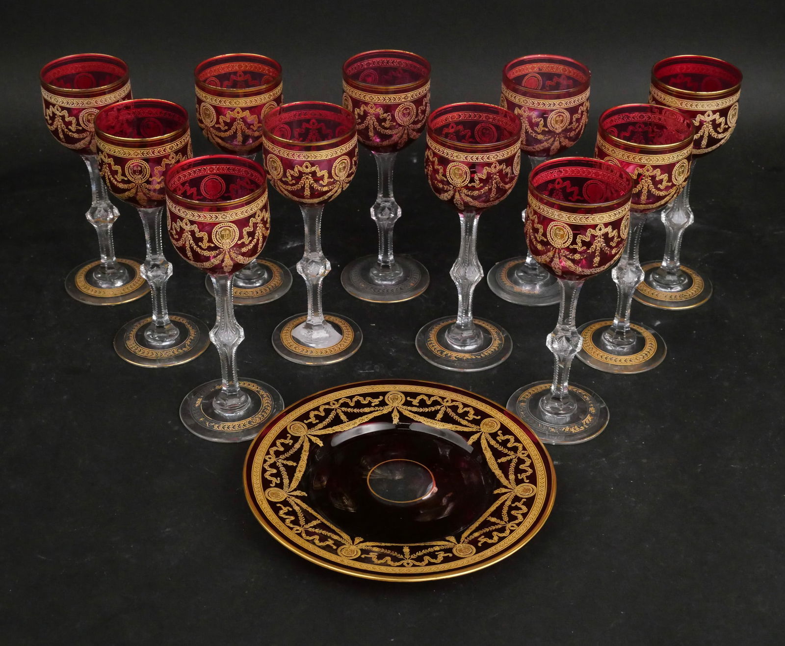 Eleven St. Louis Cranberry Crystal "Congress" Wine Glasses: Eleven St. Louis Cranberry Crystal "Congress" Wine Glasses Clear crystal with gold-encrusted lion medallions, elaborate swags, and banded borders. Together with a St. Louis Cranberry crystal plate.
