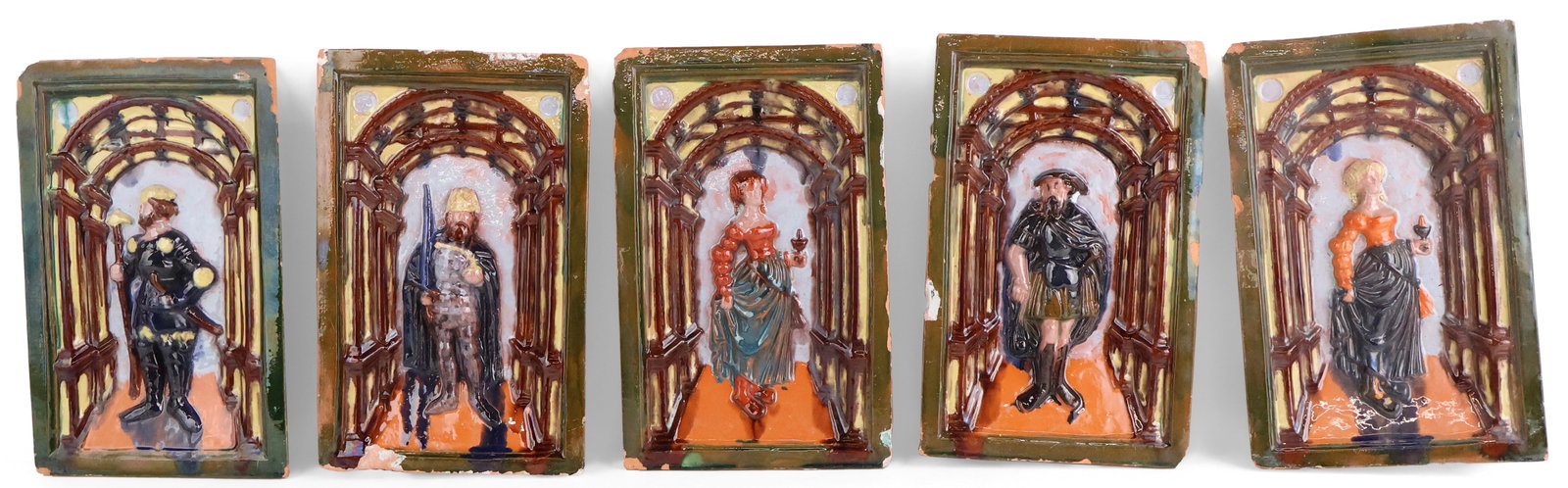 Five Majolica Tiles of Figures in Relief: Five Majolica Tiles of Figures in Relief Comprising, two women and three men. Chips, wear, surface distress. 11 3/8 x 7 1/4 x 2 in. (28.9 x 18.4 x 5.1 cm.)