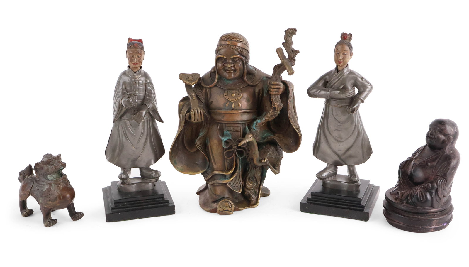 Five Asian Figures: Five Asian Figures Comprising, a pair of pewter nodders, a carved wood buddha, a brass statue of the God of Wealth, and a patinated metal fu-dog. Surface distress, wear. Largest: 9 3/4 x 7 x 5 in.