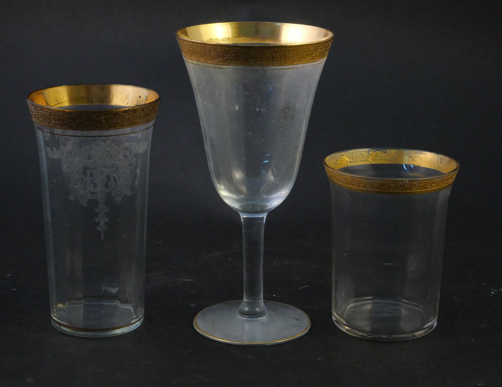 Group of Morgantown Biscayne Gold Encrusted Glassware: Group of Morgantown Biscayne Gold Encrusted Glassware Comprising, 27 goblets, 12 juice glasses, and 19 highball glasses. Various sizes. Chips, wear, surface distress. Largest: 7 x 3 1/2 in. (17.8 x