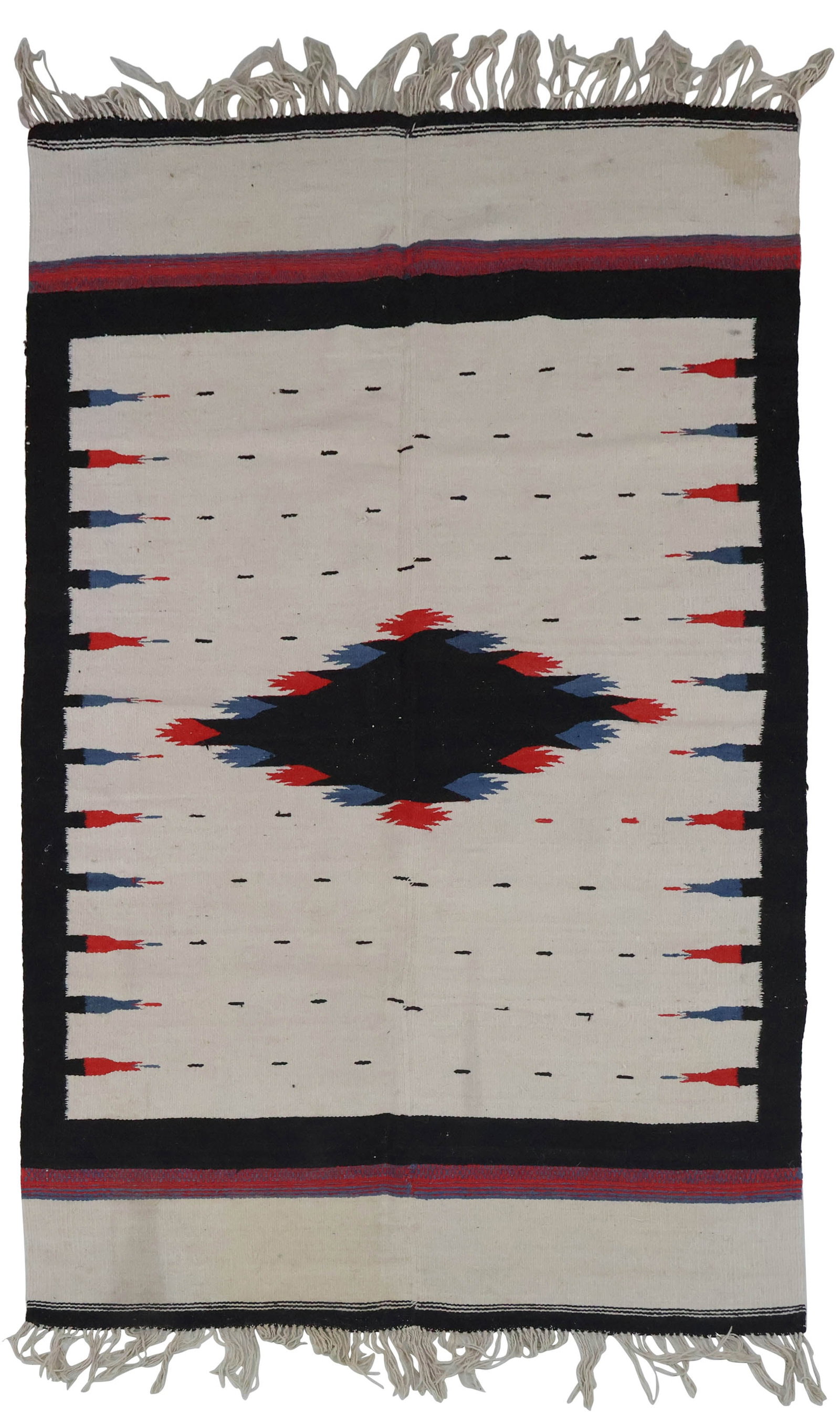 Navajo Rug: Navajo Rug First half 20th C. in red, blue, white, and black. Some stains and wear. 76 x 45 in. (193 x 114.3 cm.)