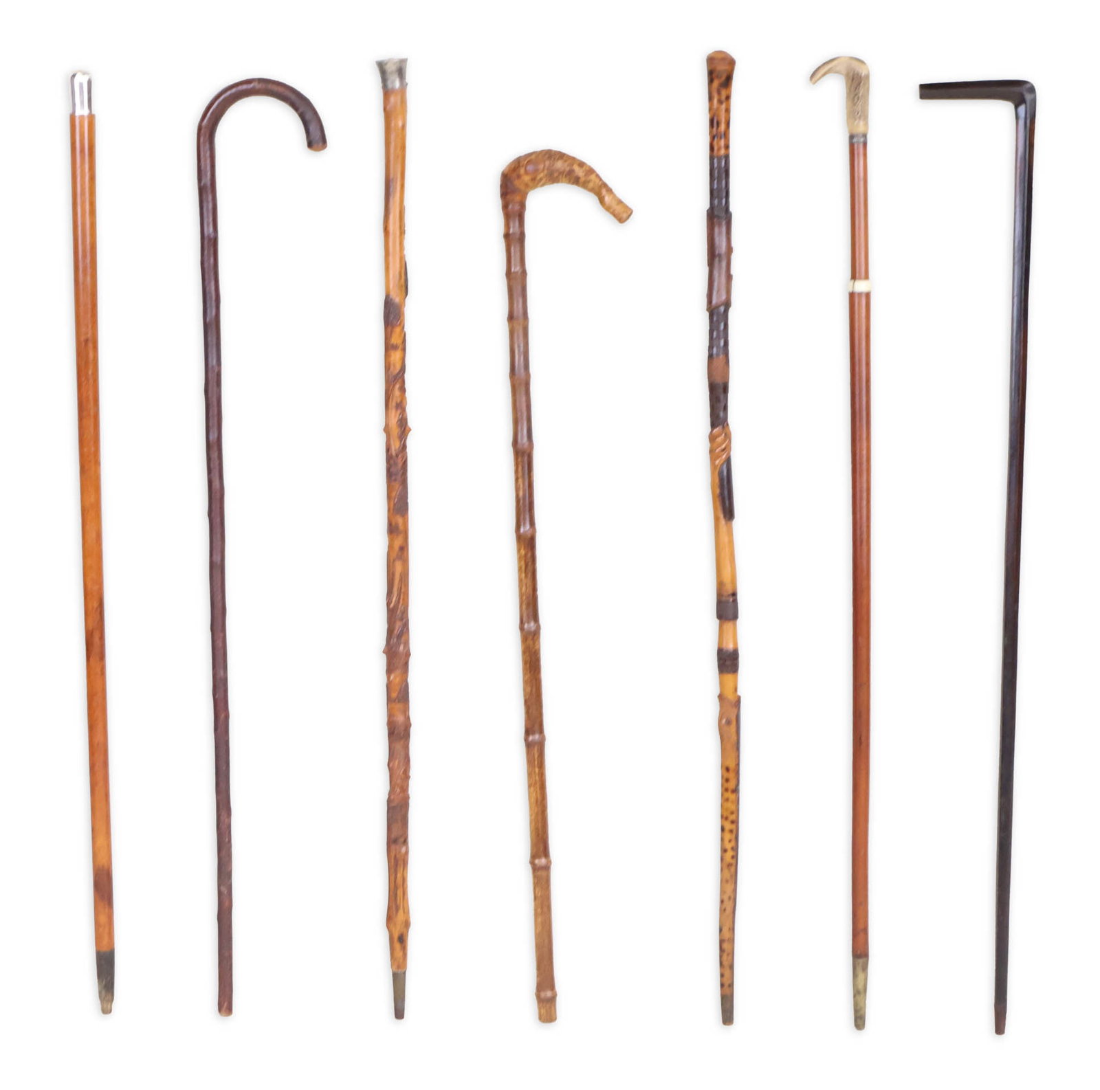 Seven Assorted Wood Canes: Seven Assorted Wood Canes One with horn pommel, some carved. Largest: 36 in. (91.4 cm.)