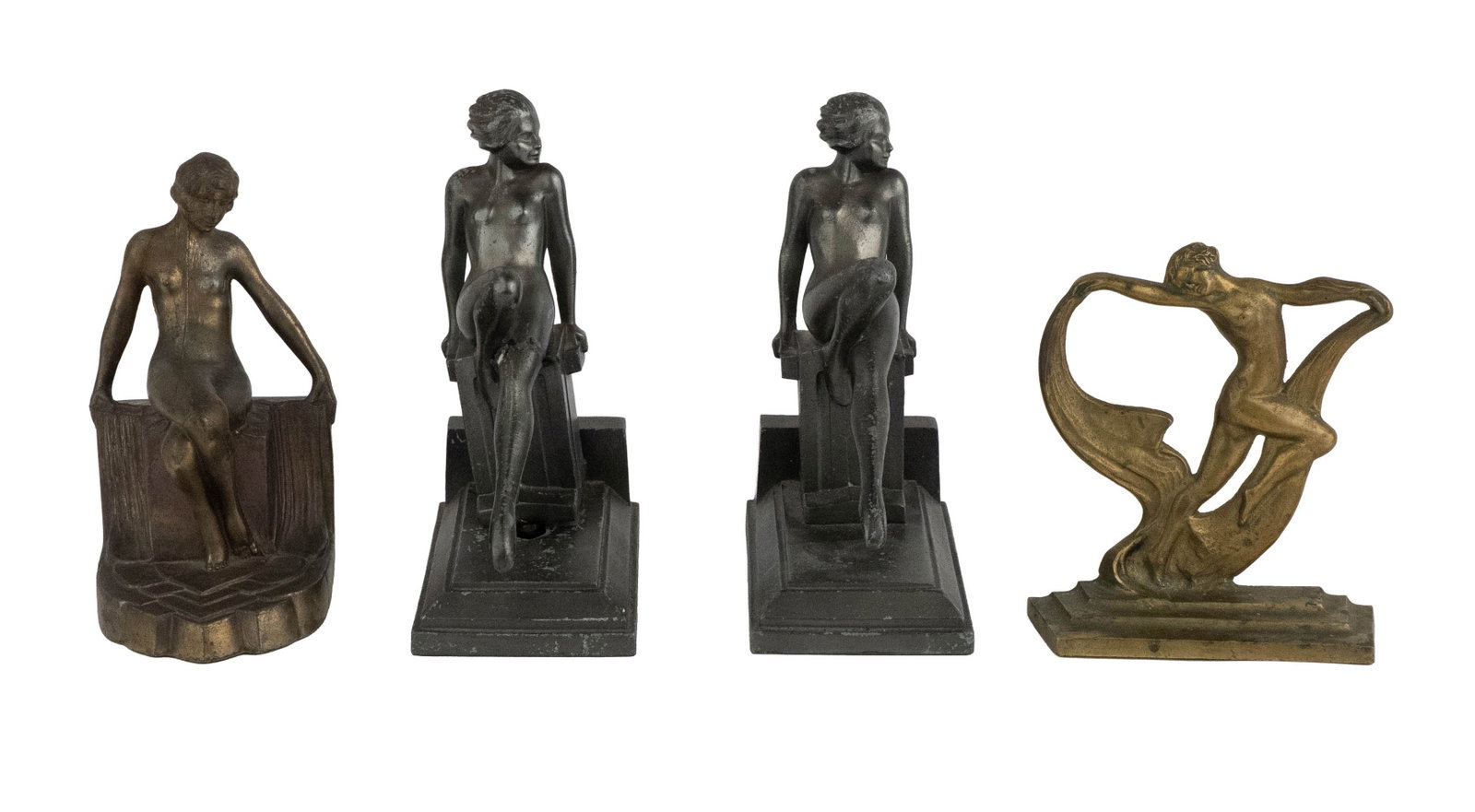 Four Art Deco Figural Bookends: Four Art Deco Figural Bookends Comprising, one pair and two singles. Losses, repairs, surface distress. Largest: 7 3/4 x 5 3/4 x 3 1/2 in. (19.7 x 14.6 x 8.9 cm.)