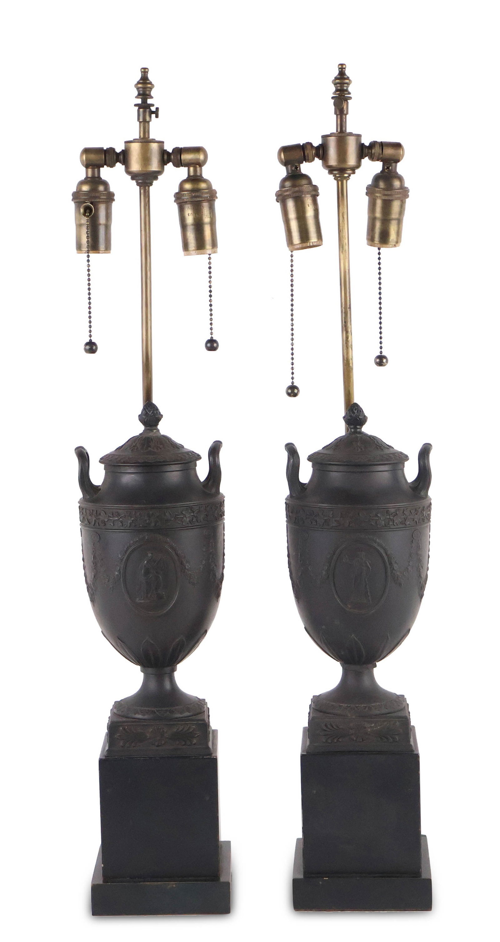 Pair of Black Basalt Table Lamps: Pair of Black Basalt Table Lamps Probably Wedgwood, mounted on wood bases and fitted as lamps. 29 x 5 1/4 x 5 in. (73.7 x 13.3 x 12.7 cm.)