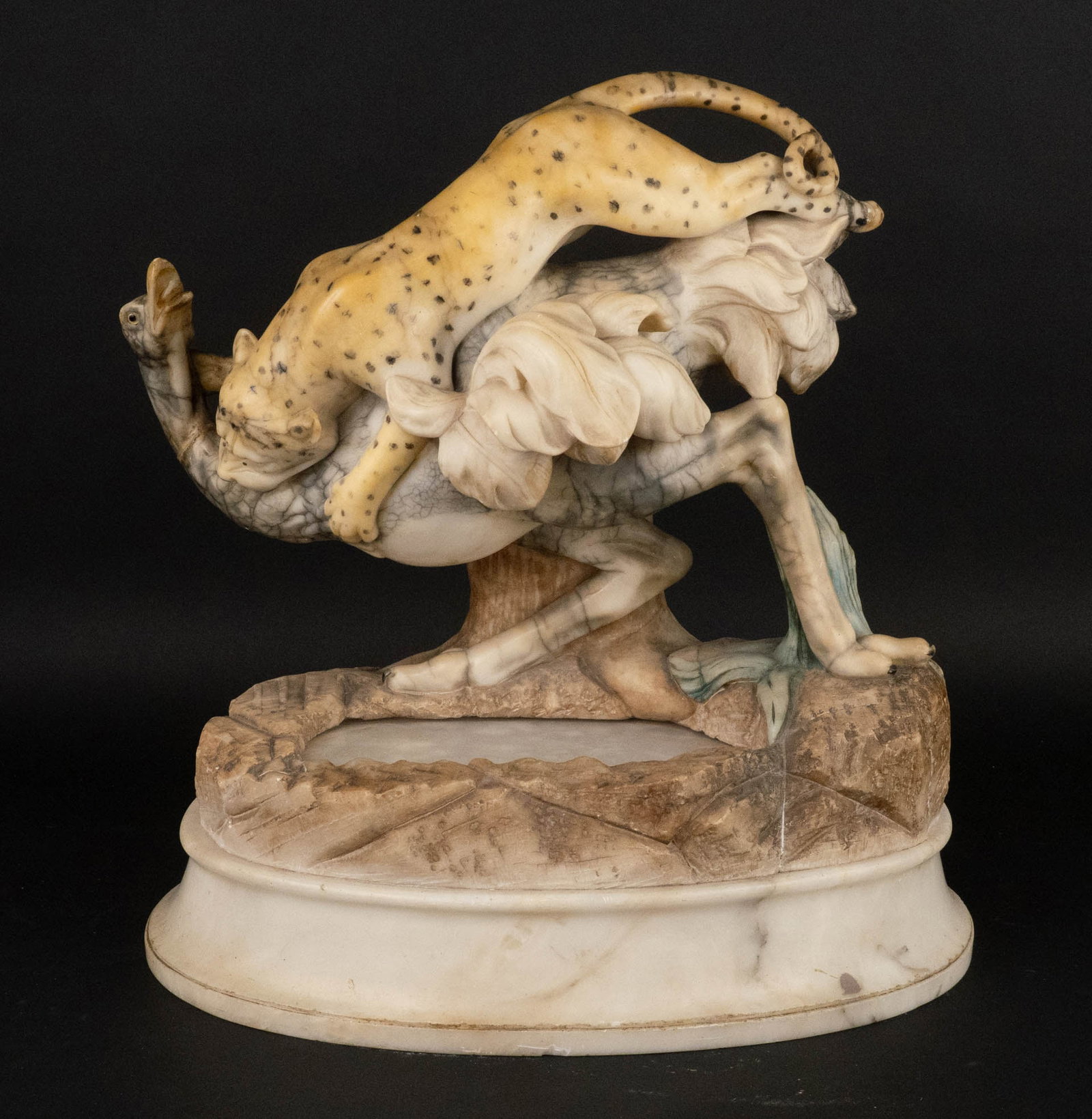 Painted Carved Alabaster Figural Group: Painted Carved Alabaster Figural Group Depicting a leopard attacking an ostrich, now electrified. Repairs to ostrich neck. 18 1/2 x 17 1/2 x 10 in. (47 x 44.5 x 25.4 cm.)