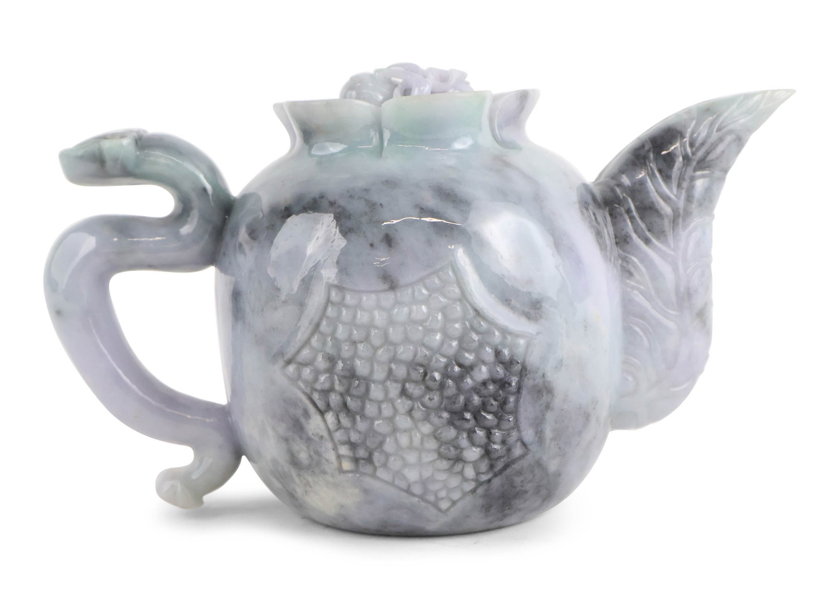 Chinese Carved Jadeite Teapot: Chinese Carved Jadeite Teapot 20th C. with dragon style handle and lotus flower and seed head incised decoration. Provenance: Property from a Private New York and German Collector 6 1/4 x 11 1/2 x 5