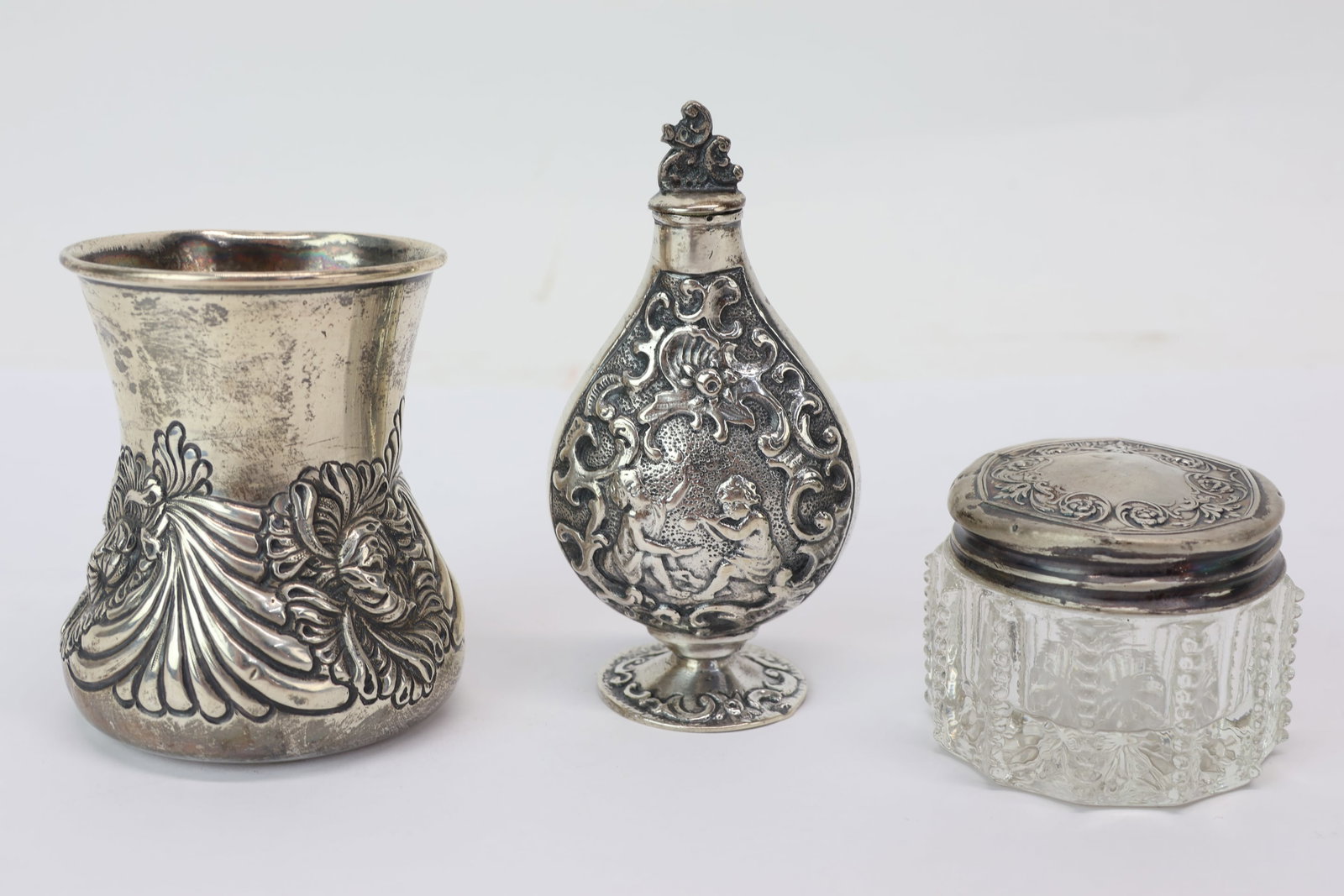 Two Sterling Silver Dresser Articles: Two Sterling Silver Dresser Articles Two Sterling Silver Dresser Articles, one a small cup with repousse design marked at underside "Sterling 215" with a Swiss cross, the other a small glass jar with