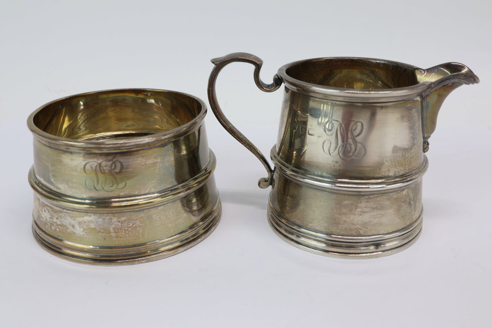 Adie Brothers Ltd Sterling Silver Creamer and Sugar: Adie Brothers Ltd Sterling Silver Creamer and Sugar Adie Brothers Ltd Sterling Silver Creamer and Sugar. Used condition, wear, worn. sugar measures 1 11/16" tall x 2 7/8" diameter at base.