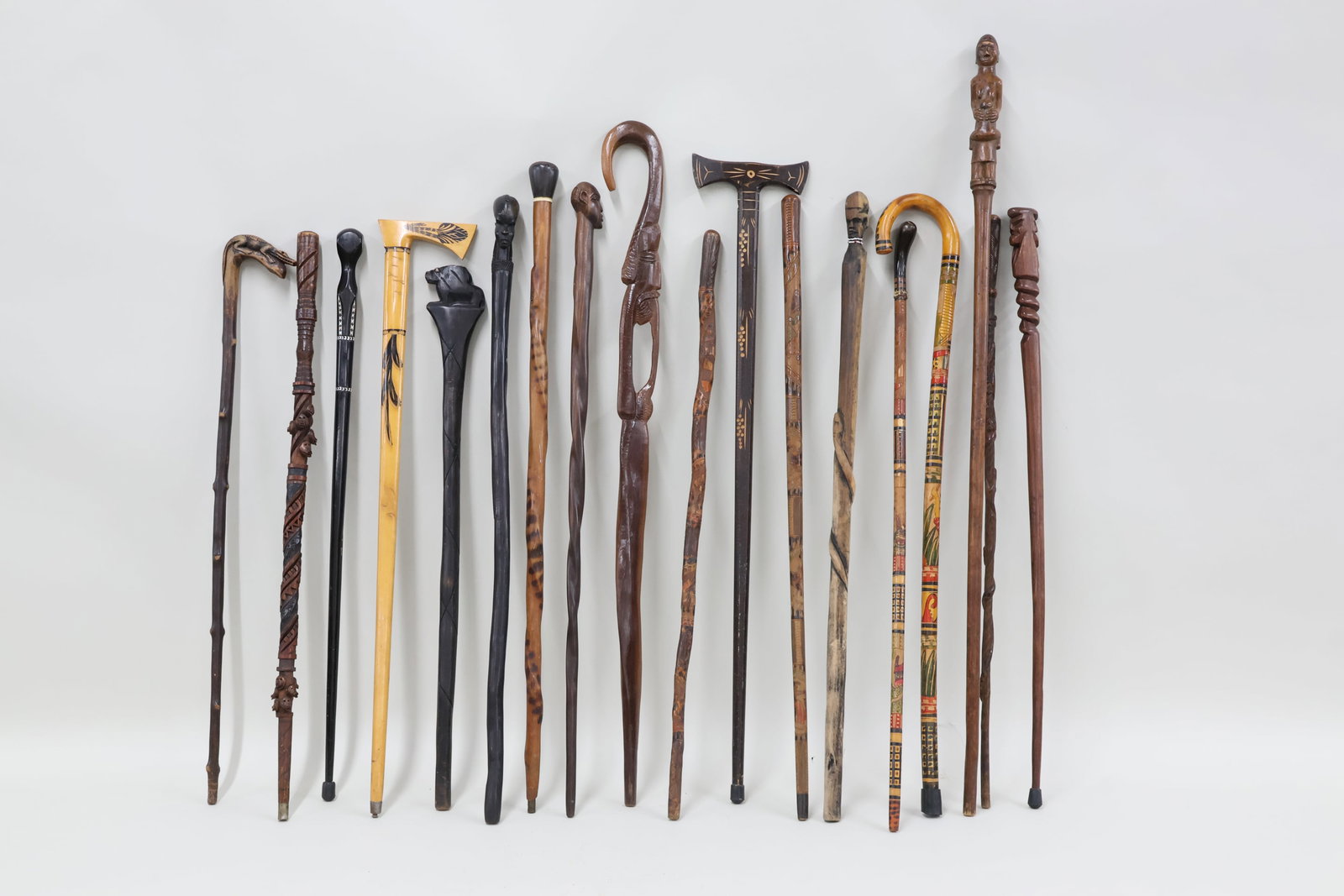 Group of Eighteen Assorted Tribal Walking Sticks: Group of Eighteen Assorted Tribal Walking Sticks Group of Eighteen Assorted Tribal Walking Sticks. Including some with carved figural design, paint decorated, and carved animals. Used condition,