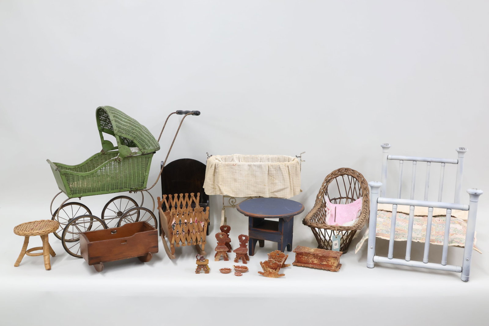 Group of Assorted Doll Furniture: Group of Assorted Doll Furniture Group of Assorted Doll Furniture including a metal green painted buggie, a wrought iron rocking bassinet, blue painted table, iron bed, and more. Used condition, wear,
