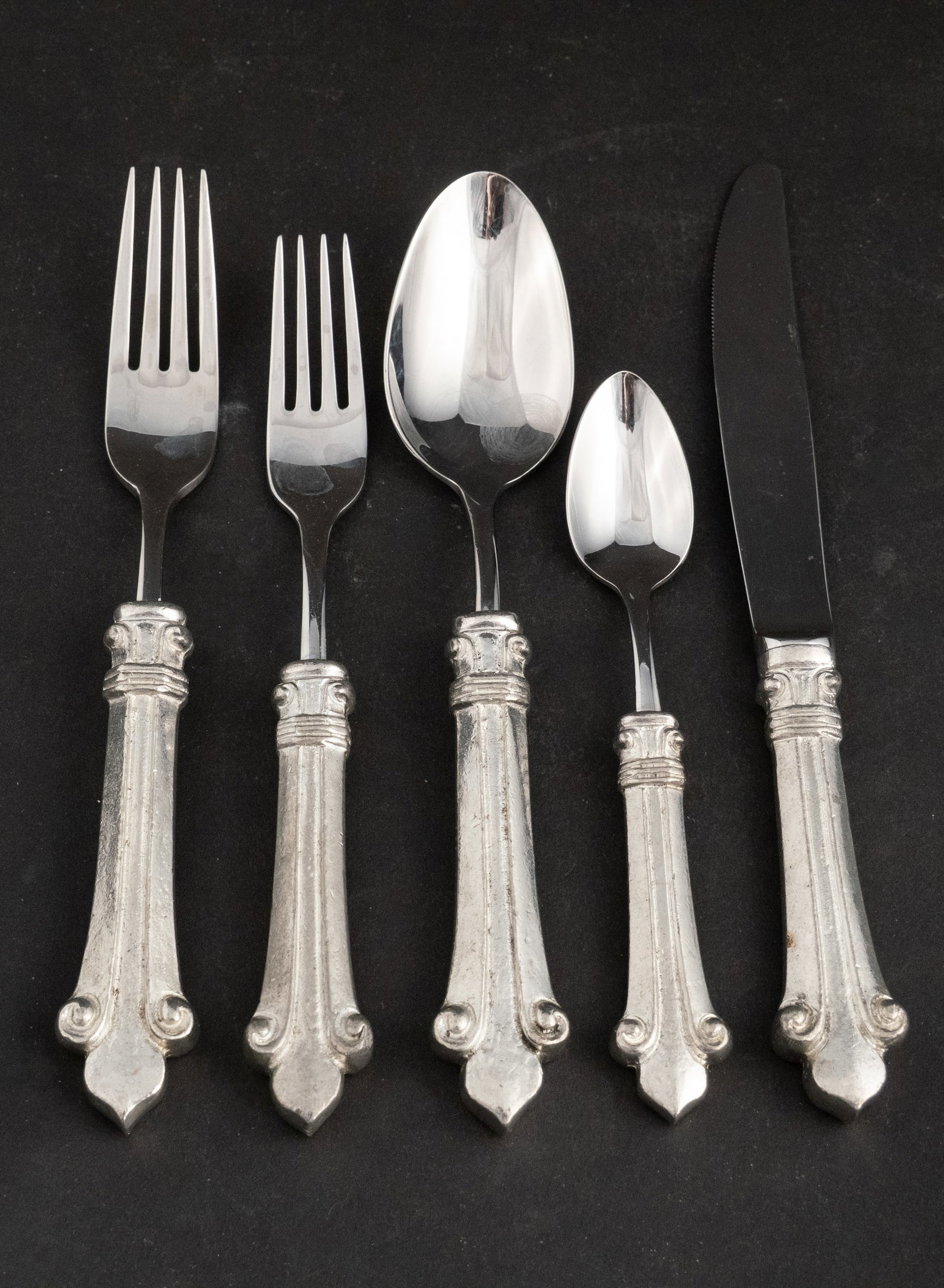 Artale Stainless Steel and Pewter Flatware: Artale Stainless Steel and Pewter Flatware Of impressive weight and design. Stamped "Artale", "VA" and 95. Including: twelve forks, 8 1/4"l, eleven forks, 7 3/4"l, twelve spoons, 8"l, twelve