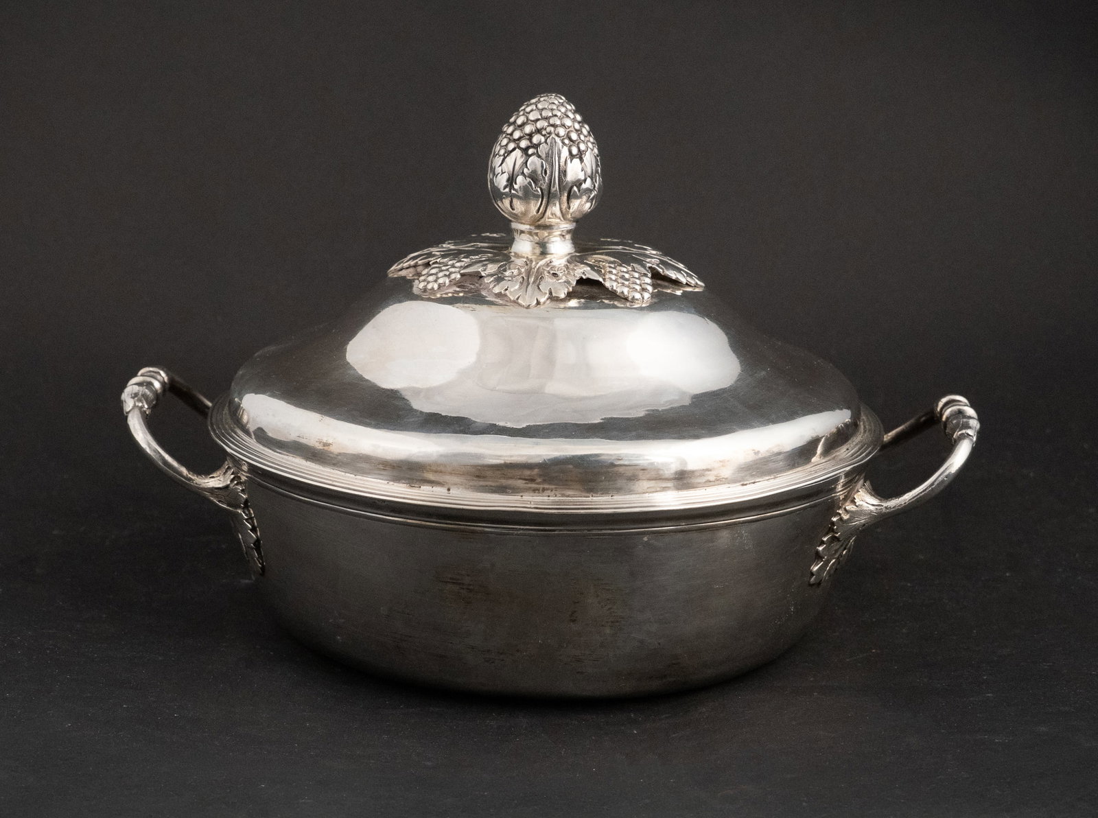 French Silver Covered Vegetable Dish: French Silver Covered Vegetable Dish Double handled with foliate and grape decorated finial. 18th C., 1789-1792, makers mark, "JB? J". Approx. 32 t.o. 6 1/2 x 9 in. (16.5 x 22.9 cm.)