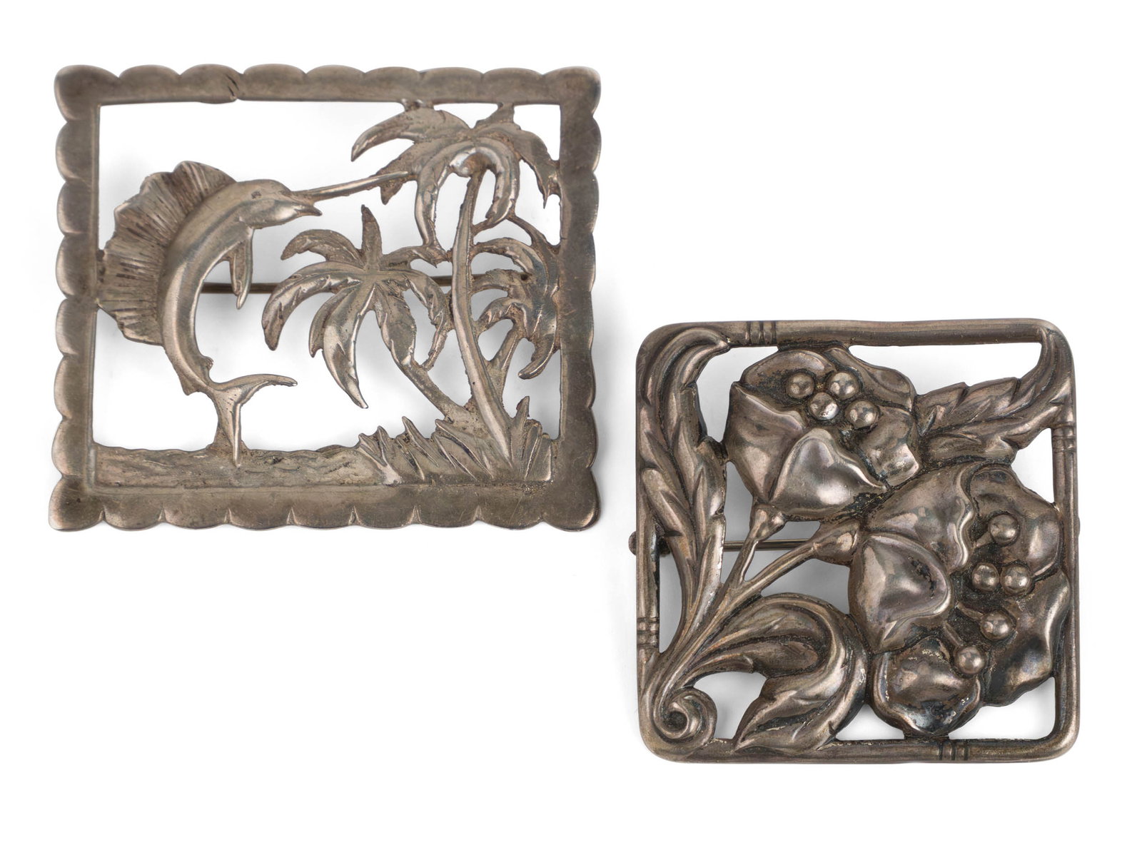 Two Silver Openwork Brooches: Two Silver Openwork Brooches The first a square floral pin marked "Danacraft", "sterling" and "reg. US patent office", the second with a sailfish and palm trees, likely Mexican, unmarked. Total