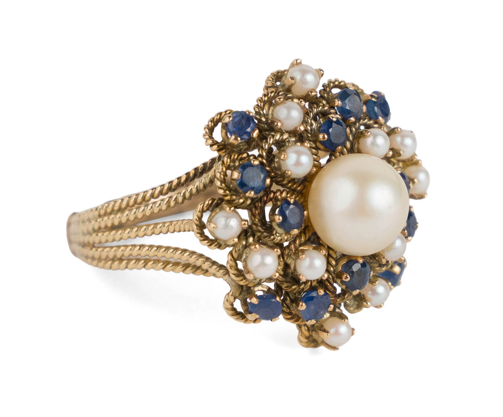 Gold, Pearl and Sapphire Cocktail Ring: Gold, Pearl and Sapphire Cocktail Ring 1950s/60s, with one large pearl, 11 smaller pearls, and 12 sapphires. Ring size 11 Total weight approx. 7 dwt 1 x 1 x 1 1/2 in. (2.5 x 2.5 x 3.8 cm.)