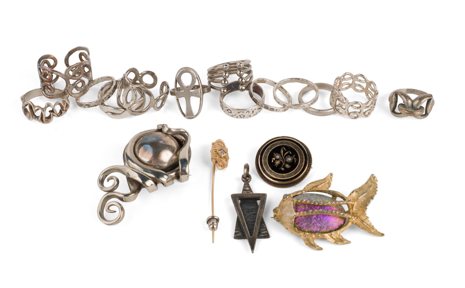 Thirteen Assorted Women's Silver Toned Rings: Thirteen Assorted Women's Silver Toned Rings Some marked sterling, some untested. Together with a silver tone brooch, a fish form brooch, a circular brooch, a pendant, and a stick pin.