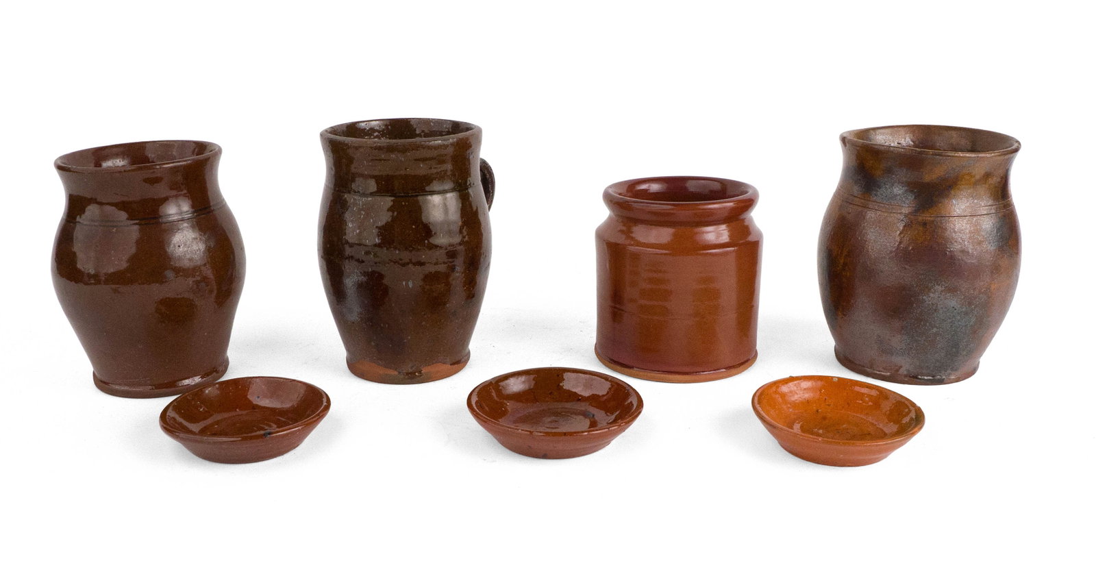 Miscellaneous Group of Redware: Miscellaneous Group of Redware 19th C. and later. Comprising two small jars, a handled mug, a modern Old Sturbridge Village jar, and three small dishes; 7 pieces. One is a Jugtown piece. Provenance: