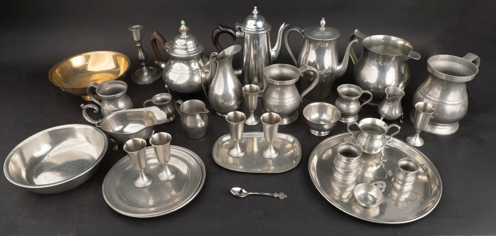 Large Group of Pewter Table Articles: Large Group of Pewter Table Articles Including, plates, bowls, pitchers, mugs, and measures. Together with a brass bowl. Approx. 31 pieces Provenance: Property of a Private Bernardsville, NJ