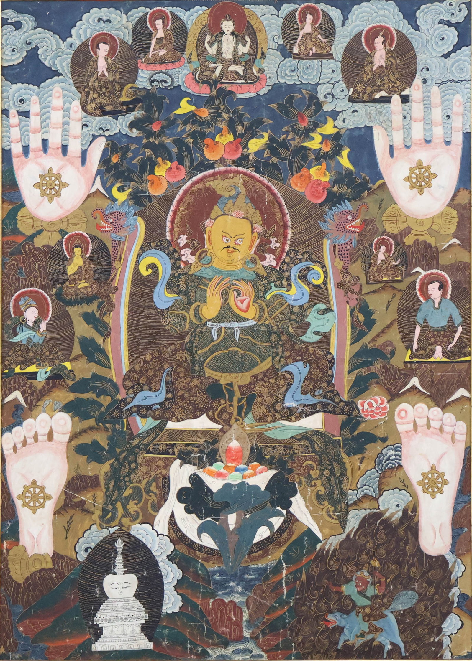 Framed Tibetan Thangka: Framed Tibetan Thangka With central figure of Jambhala and hand and footprints of the Buddha. Sight: 41 1/2 x 30 in. (105.4 x 76.2 cm.), Frame: 46 3/4 x 35 1/4 in. (118.7 x 89.5 cm.)